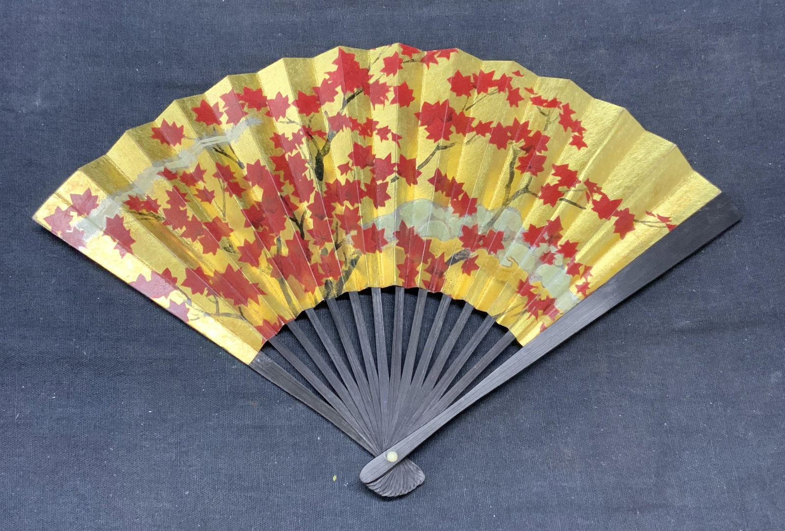 Vintage Japan Airlines Gilt Maple Tree Folding Fan: Vintage Japan Airlines gilt paper folding fan with maple tree motif. Marked Japan Airlines to reverse. Plastic and paper. Measures approx. 10 inches wide. Some wear to material consistent with exposur
