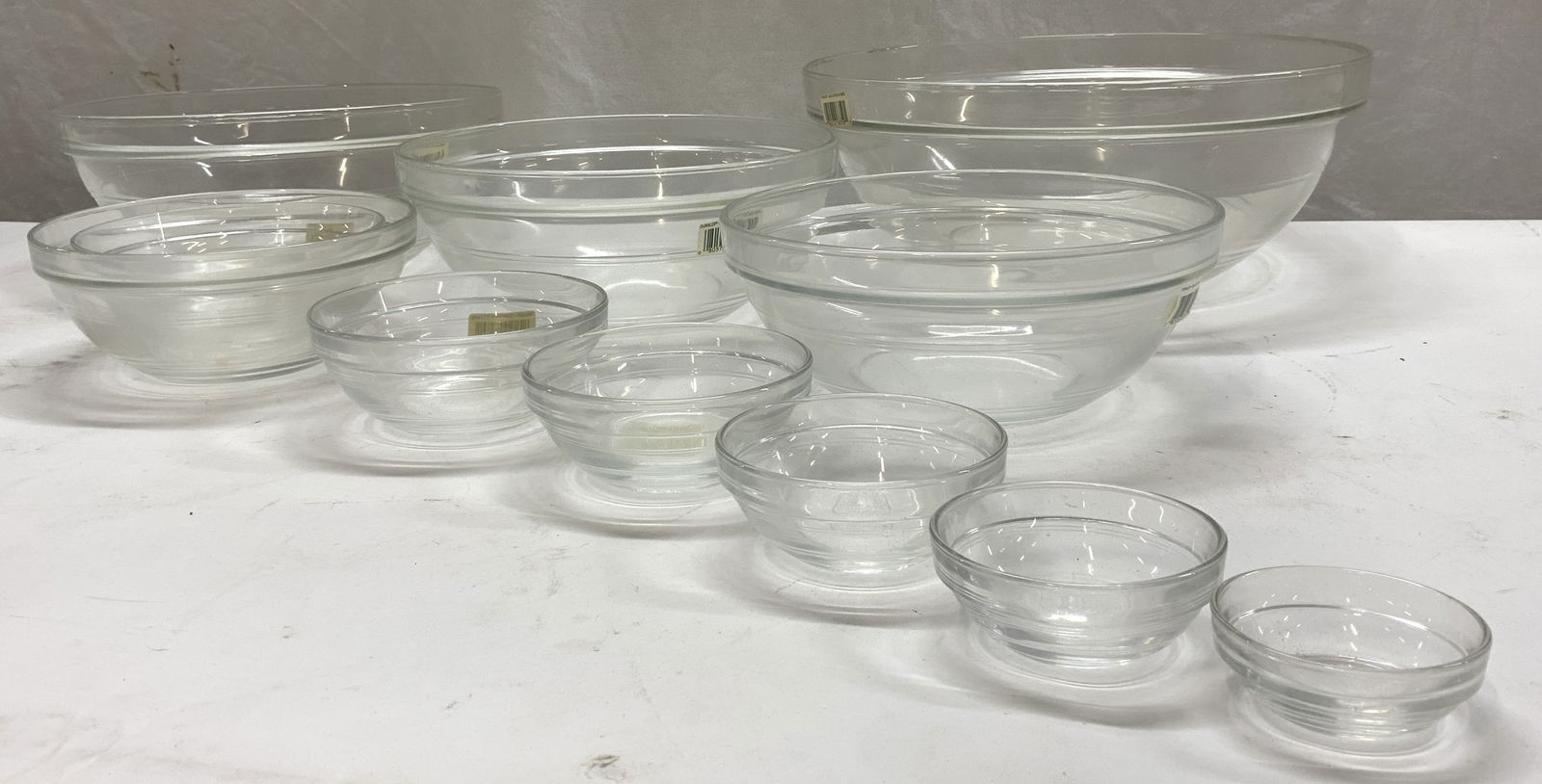11 Duralex Glass Mixing Bowls 11 NWT France: Large set of kitchenware- nesting glass bowls- mixing bowls, tableware, kitchenware. Made in France, New old stock. many bowls with labels. Largest bowl measures 12 in. Diameter. 4.75 in. Ht. Smallest