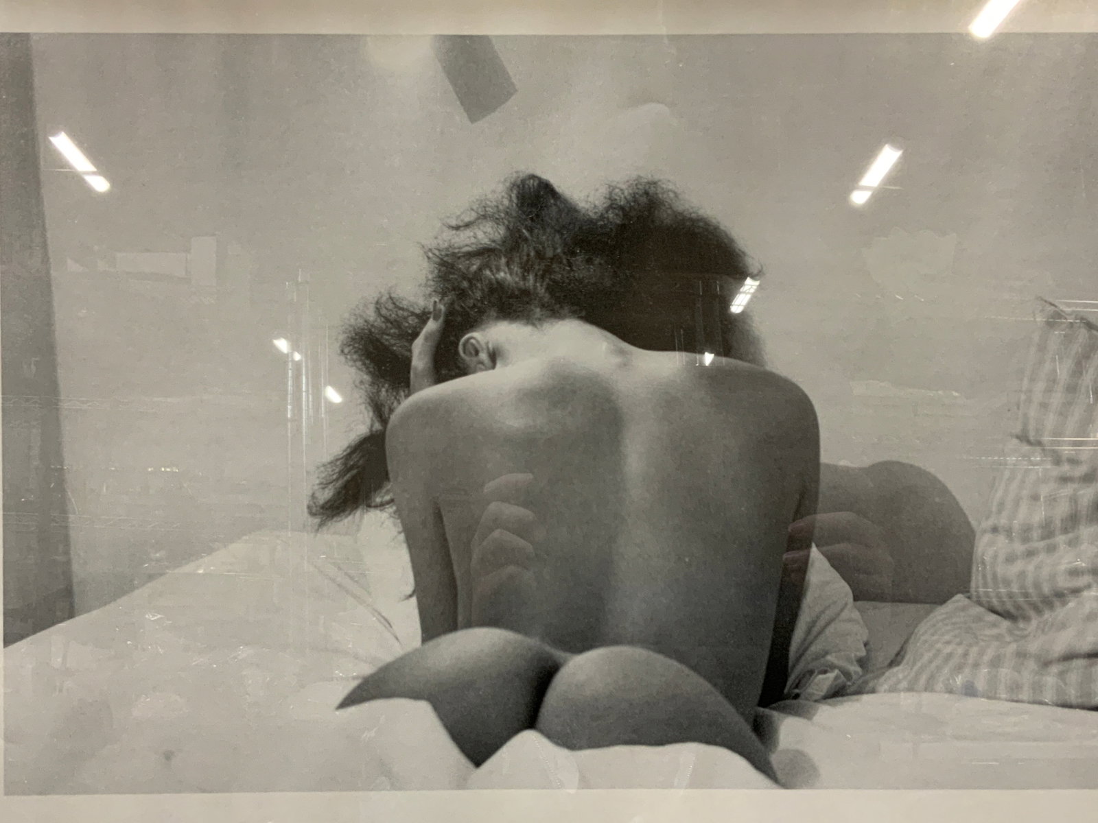 Laurence Sackman Black & White Litho: Framed photograph lithograph with margin reading Laurence Sackman. Depicting the backside of a nude woman on a bed. Framed in black wooden frame. Approximately 21.5 x 27.5 window measures 17.5 x 23.5 