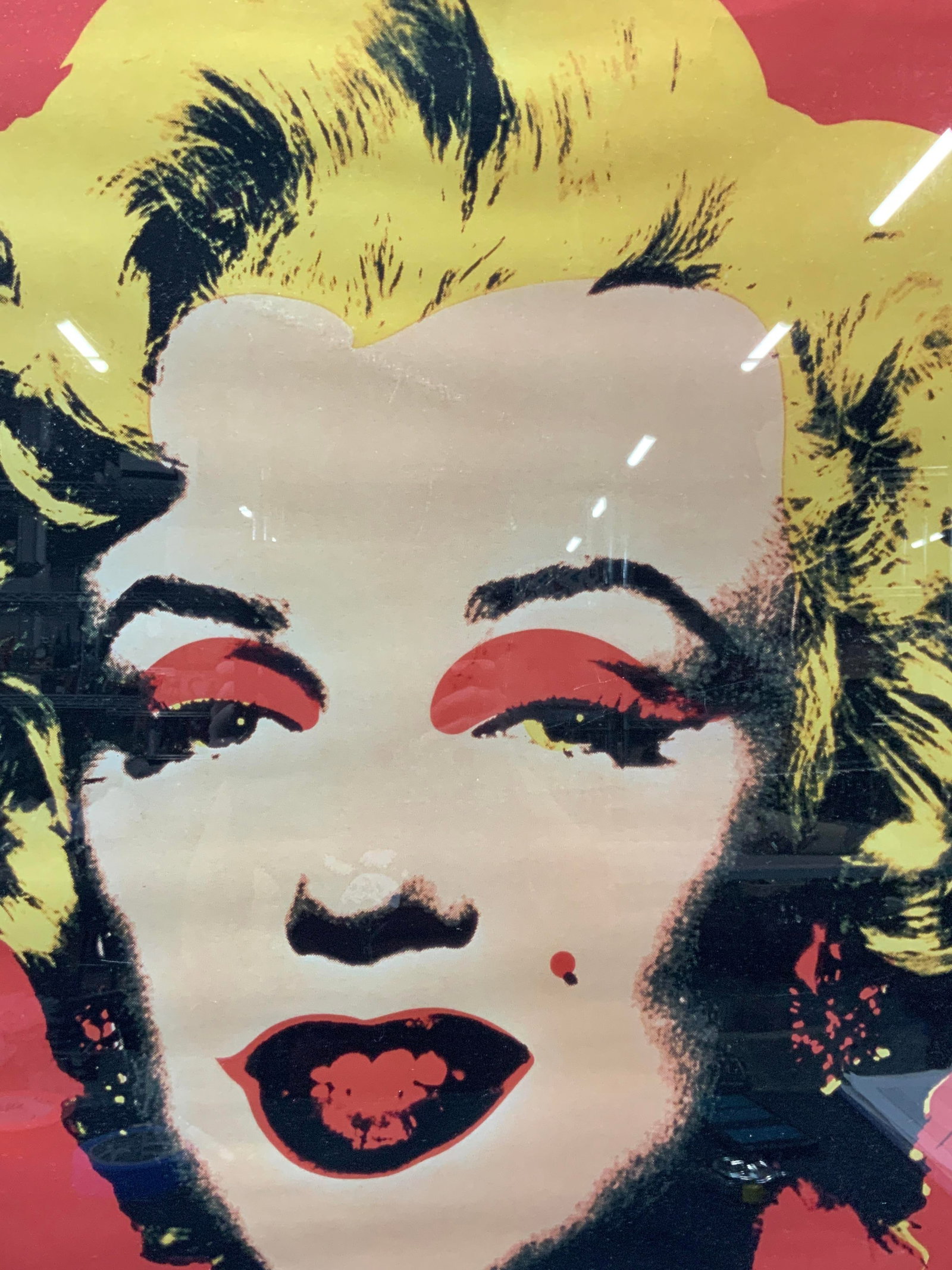 Warhol Marilyn Pop Art Litho: Pop art lithograph of Warhols Marilyn, depicting the icon in bright colors. Framed in a black metal frame with black matting. Approx 32 x 32 inches window measures 25 x 25 inches. Moderate wearing to 