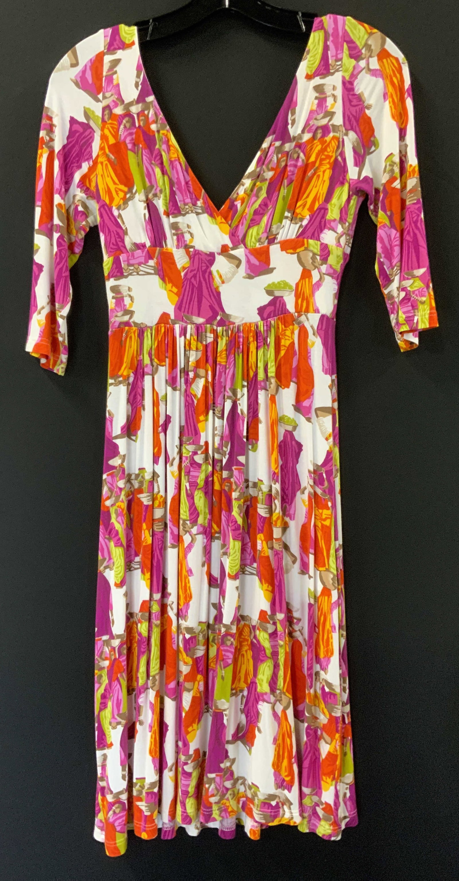Manuel Canovas Casual Tribal Market Dress: Deep and wide V neck dress in brilliant colors of magenta, orange, yellow and green on a white background with figurals carrying goods in a market. viscose with stretch, pleated waist. Size 6/8. 27 in