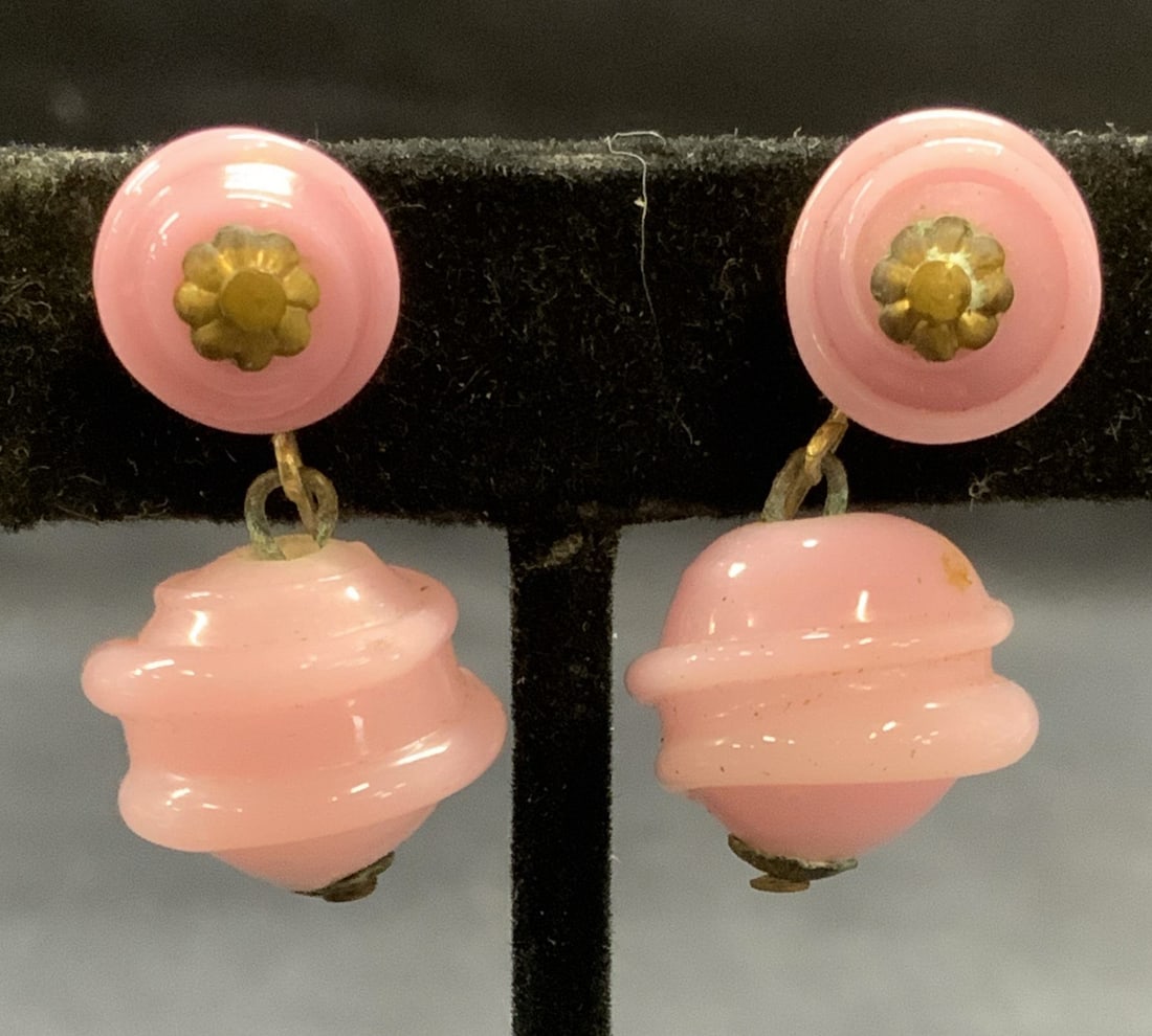 Vintage Vogue Jewelry Pink Lucite Earrings: Vintage Vogue Jewelry gold tone molded pink lucite earrings. Clip on backing. Signed to backing. Measure approx. 1 inch long. Some surface wear including scratching observed. Estate jewelry, costume j
