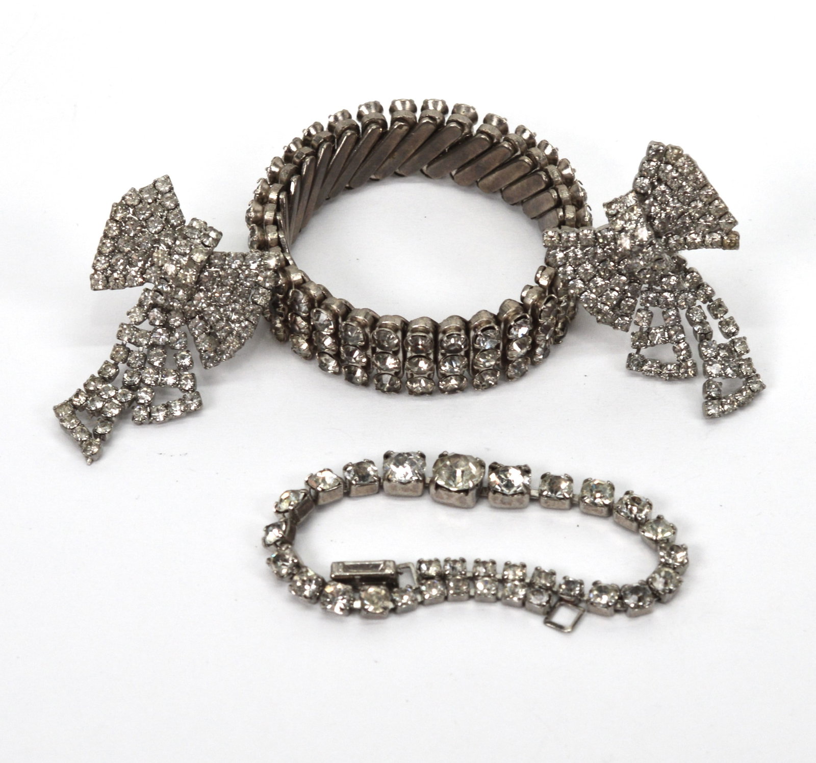 Vintage Collection of Rhinestone Jewelry 3 Pieces: This collection of well made vintage rhinestone jewelry includes a very well made, stretchable bracelet that will fit up to a 6.5 in wrist, a 6 in tennis bracelet and a great pair of clip on bow tie e
