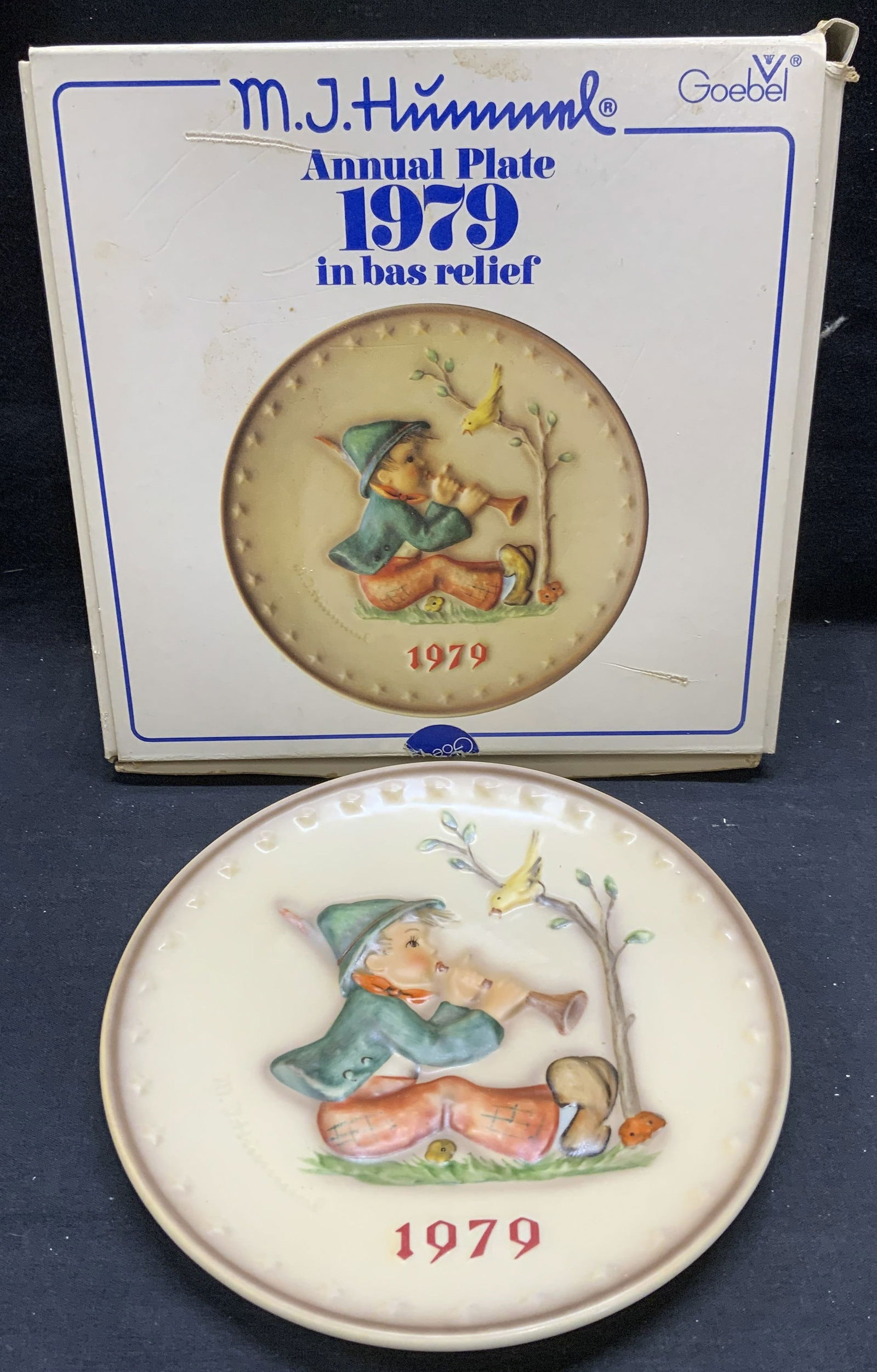 GOEBEL Hummel 1979 Annual Porcelain Plate: GOEBEL MJ Hummel 1979 Annual porcelain plate with original box. Bas relief figural and bird motif. Trademarked to underside. Plate measures approx. 7.5 inches diameter. Box measures approx. 9 x 9 x 2
