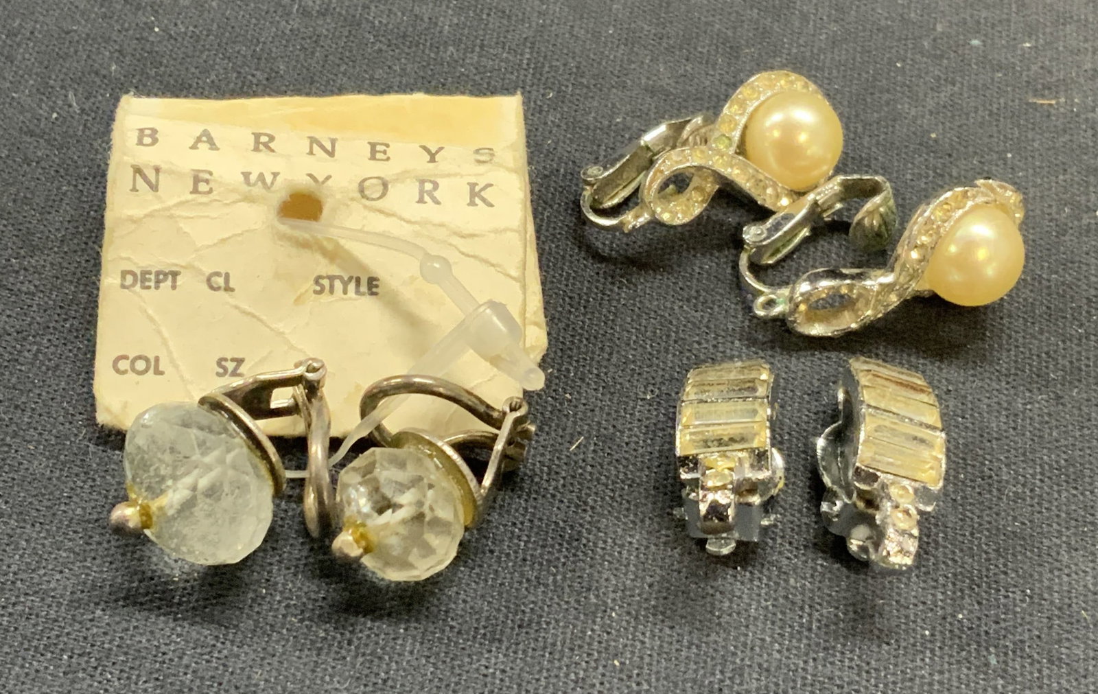Lot 3 PANETTA & Barneys Crystal Earrings: PANETTA silver tone faux pearl clip on earrings. Signed to backing. Barneys silver tone crystal clip on earrings. New with tag. Vintage silver tone crystal clip on earrings. Largest pair measure appro