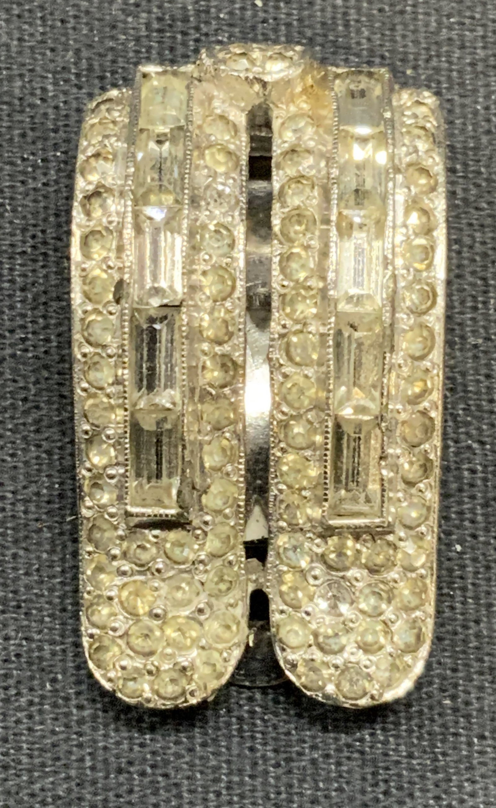 Vintage Silver Tone Crystal Dress Clip: Vintage silver tone crystal decorated dress/sweater clip. Measures approx. 1 3/8 x .75 inches. Some surface wear including scratching observed. Estate jewelry, costume jewelry, cocktail jewelry, fashi