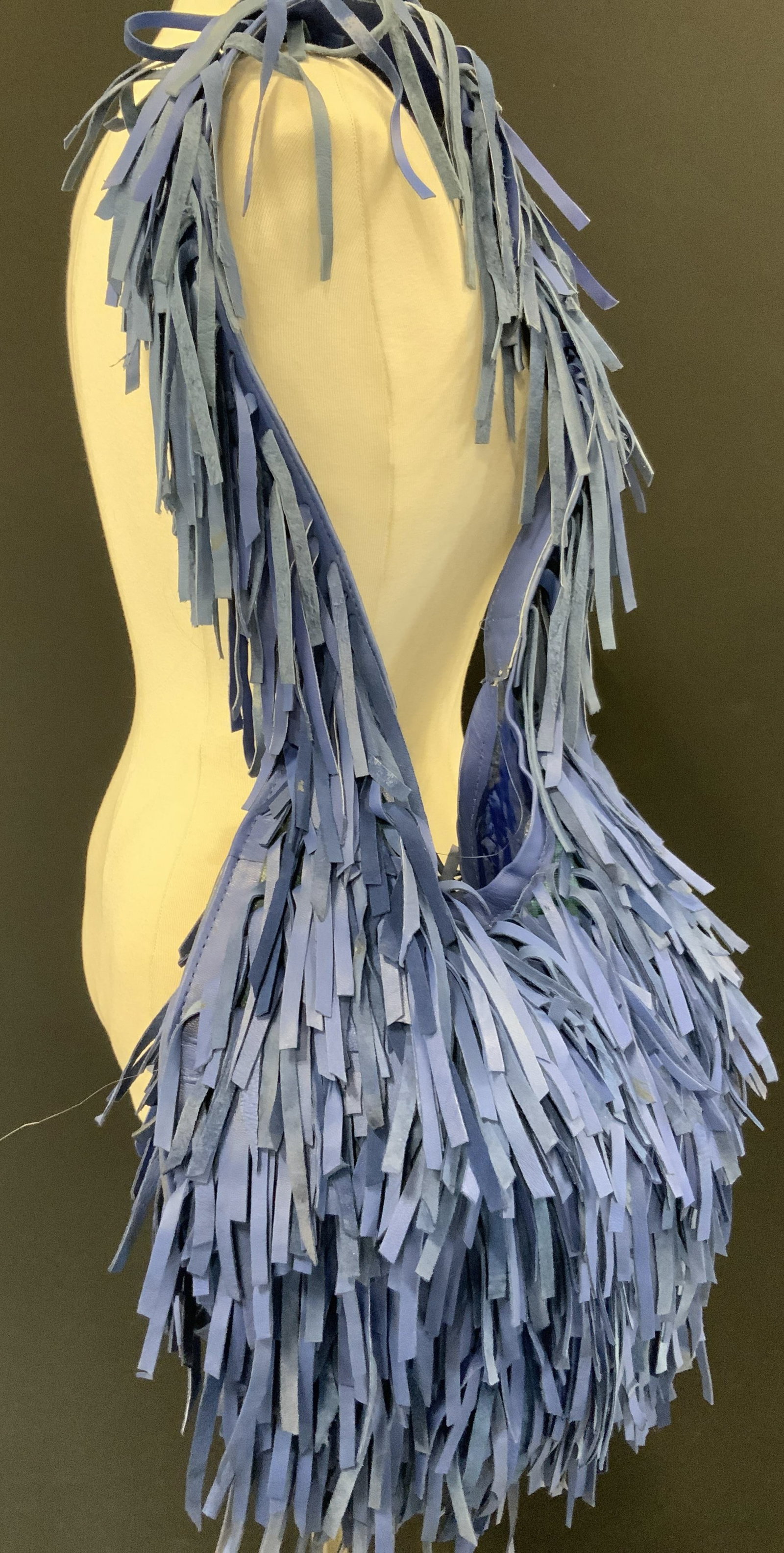Vtg Fringe Leather Shoulder Bag: Vintage Shoulder bags with blue toned leather exterior adorn in fringe leather strips throughout the body of the bag and shoulder strap. Interior is lined with fabric and has interior pockets. Approx 