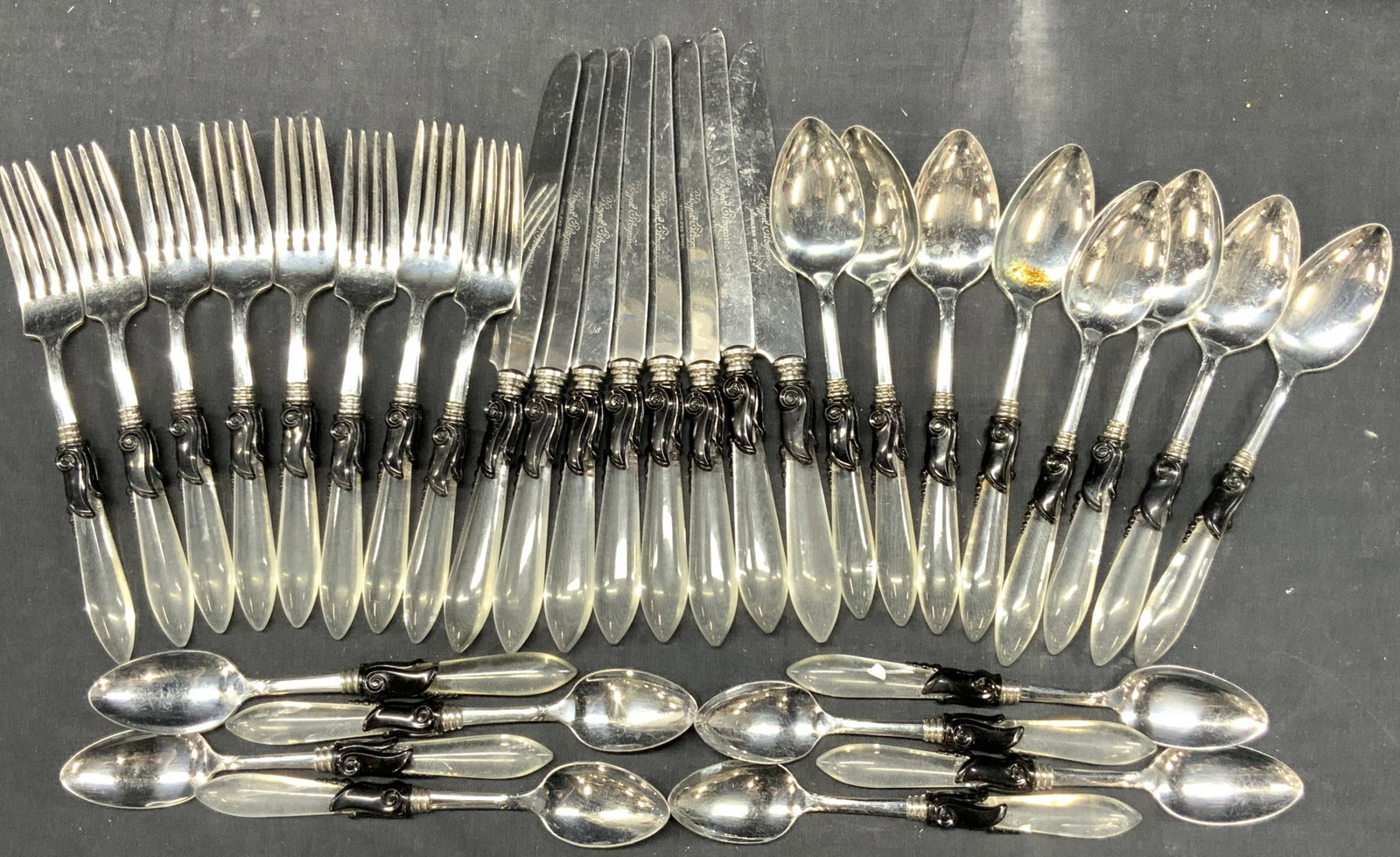 Set 33 Permabrite Acrylic Handled Utensils: Set 33 of utensils with black and clear Acrylic crafted handles. Marked Perma brite on undersides and marked stainless steel on knives. 8 knives, 8 tablespoons, 9 forks, and 8 tea spoons. Longest bein