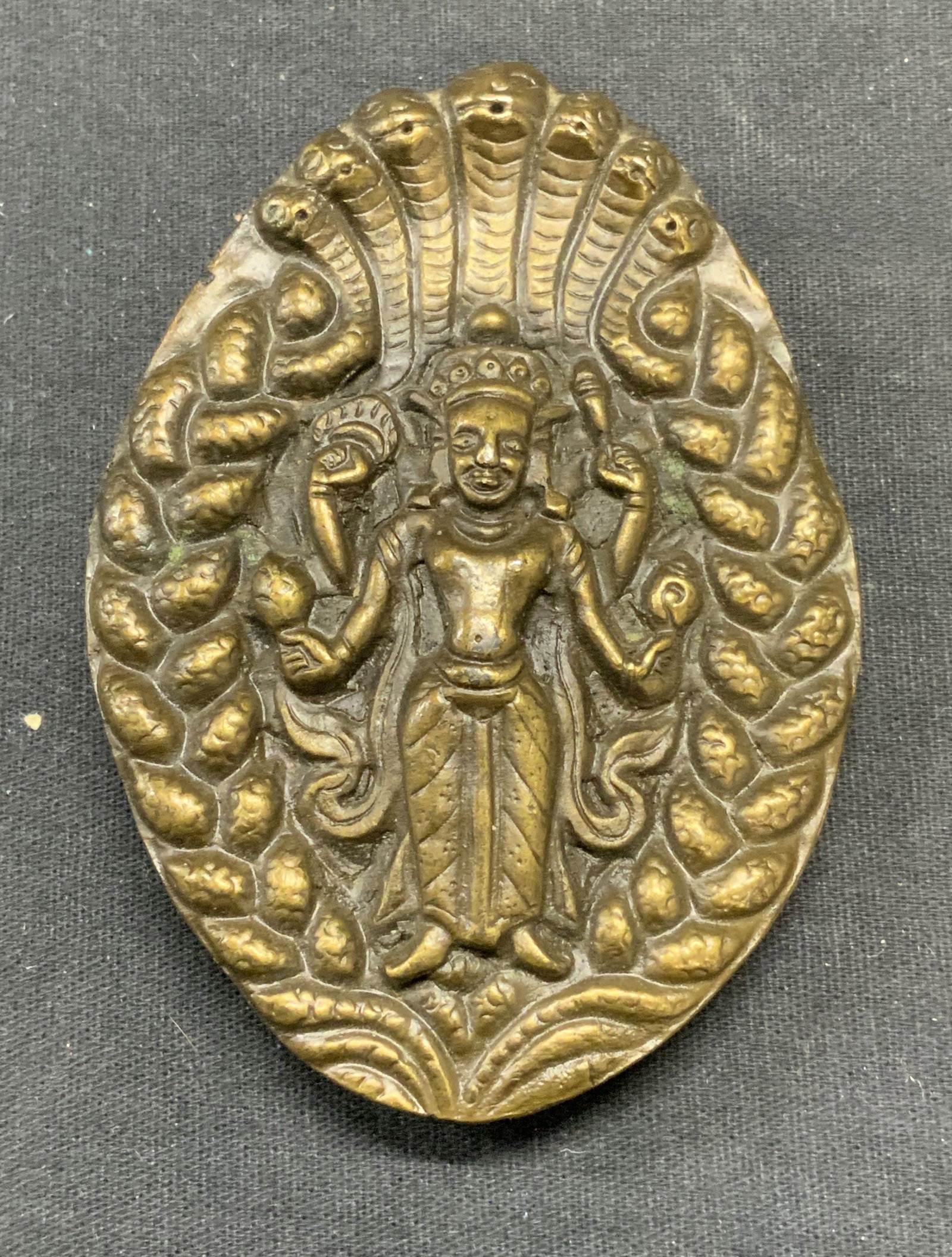 1974 Bergamot Brass Works Hindu Deity Belt Buckle: Vintage 1974 Bergamot Brass Works belt buckle with raised Hindu deity motif. Signed to underside. Piece has weight. Measures approx. 3.5 x 2.5 inches. Some surface wear including scratching observed. 