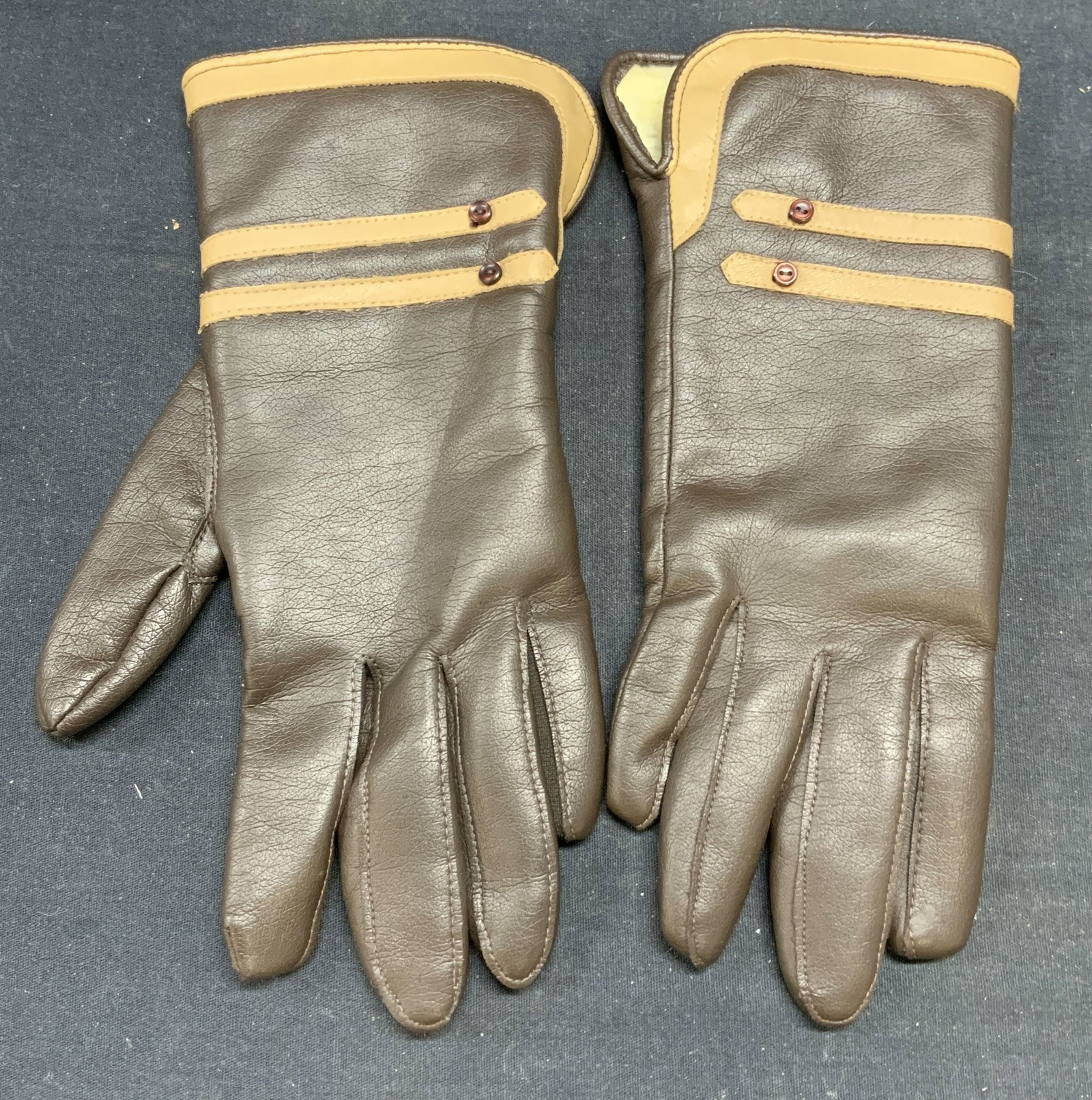 Alexanders Brown Leather Style Gloves: Alexanders brown leather style gloves. All synthetic material. Measure approx. 10 inches long. Some wear to material consistent with exposure. Alexander gloves, ladies designer gloves, ladies designer