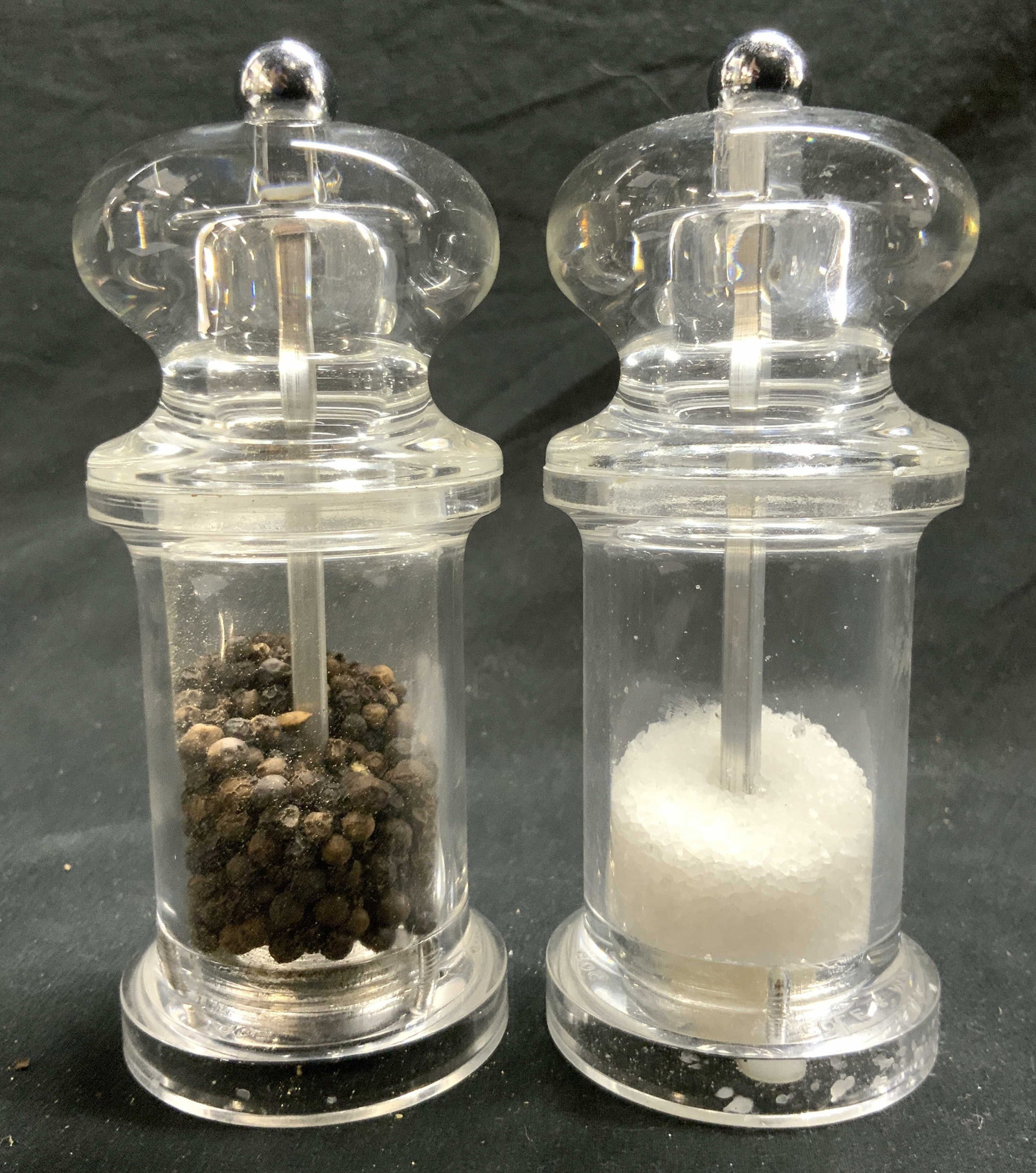 COLE & MASON Acrylic Salt & Pepper Shakers: Undersides are inscribed COLE & MASON ENGLAND. Lot includes 1 salt and 1 pepper shaker. Each piece is acrylic. Each grinder has silver toned metal spherical shaped top. Each measures approximately 5.5