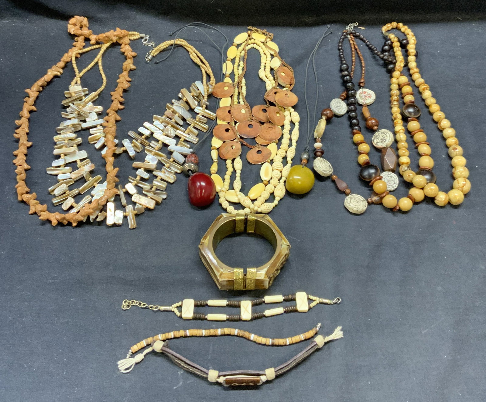 Lot 15 Beaded Necklaces & Bracelets: Lot of 15 beaded necklaces and bracelets. Stone, metal, mother of pearl, ceramic, and composite. Largest necklace drop length approx. 14.5 inches. All pieces have some surface wear including scratchin