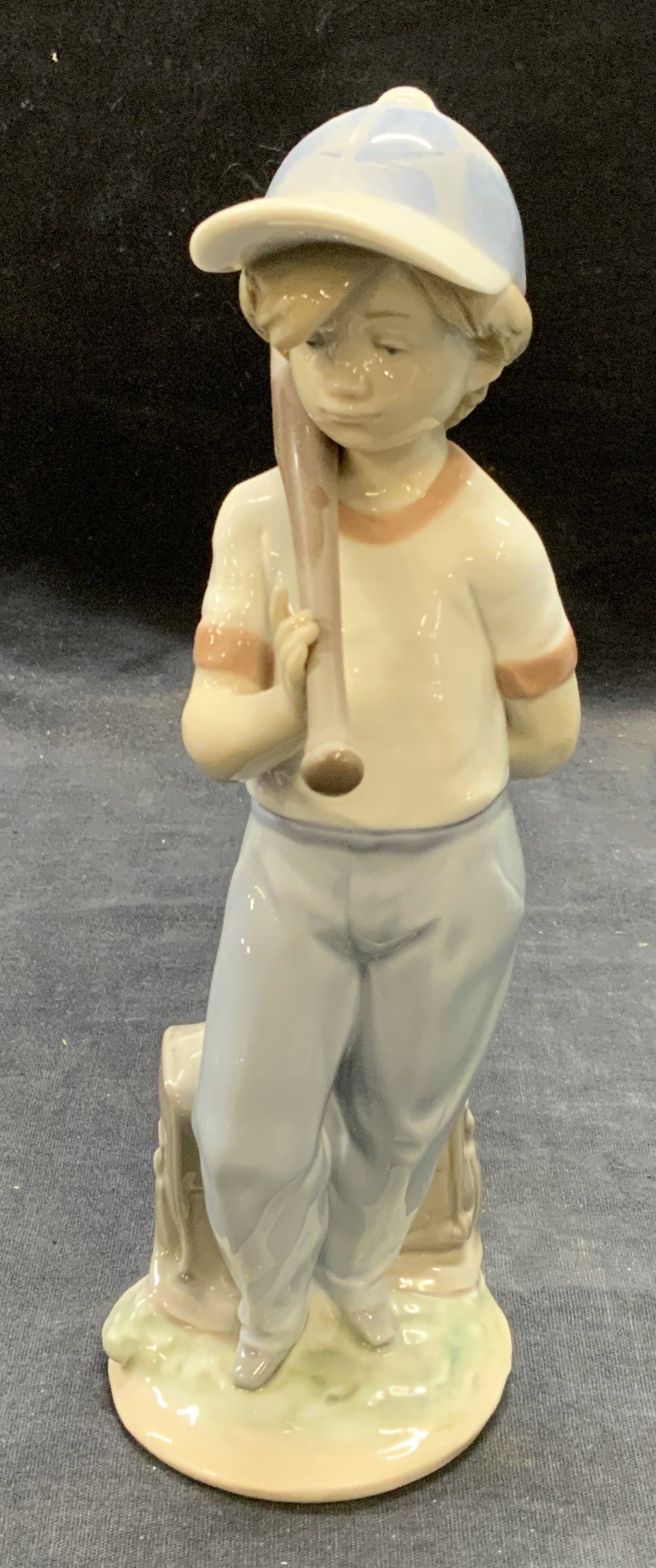 Lladro Porcelain Baseball Child Figural Spain, Box: Lladro porcelain baseball child figural. Trademarked to underside. Made in Spain. Includes original box. Measures approx. 2.75 x 4 x 8.25 inches. Some surface wear consistent with exposure. Lladro, Ll