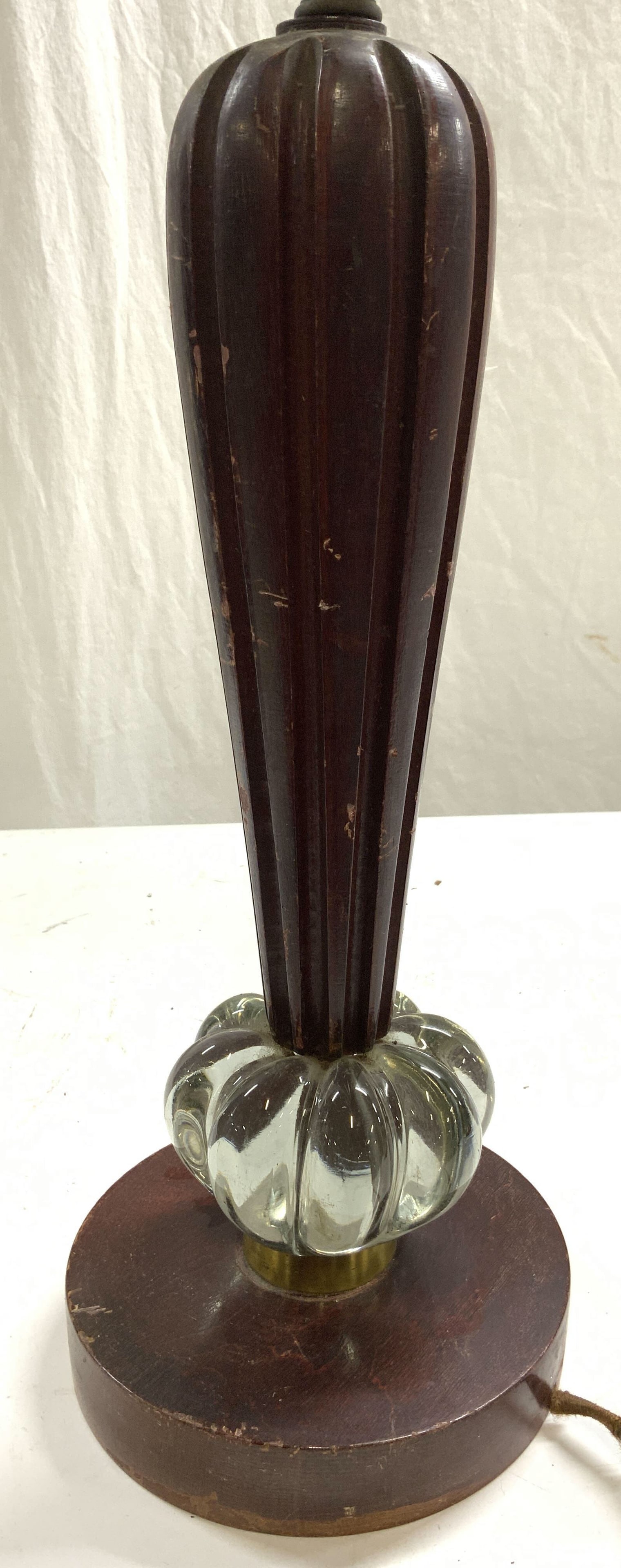 Antique Carved Wood & Glass Lamp: Lamp is wooden & glass. Piece is circular shaped base. Lamp appears to be antique possibly vintage. Piece includes harp & finial. Lamp measures approximately 27.5 inches tall 6.75 inches wide. Lamp, a
