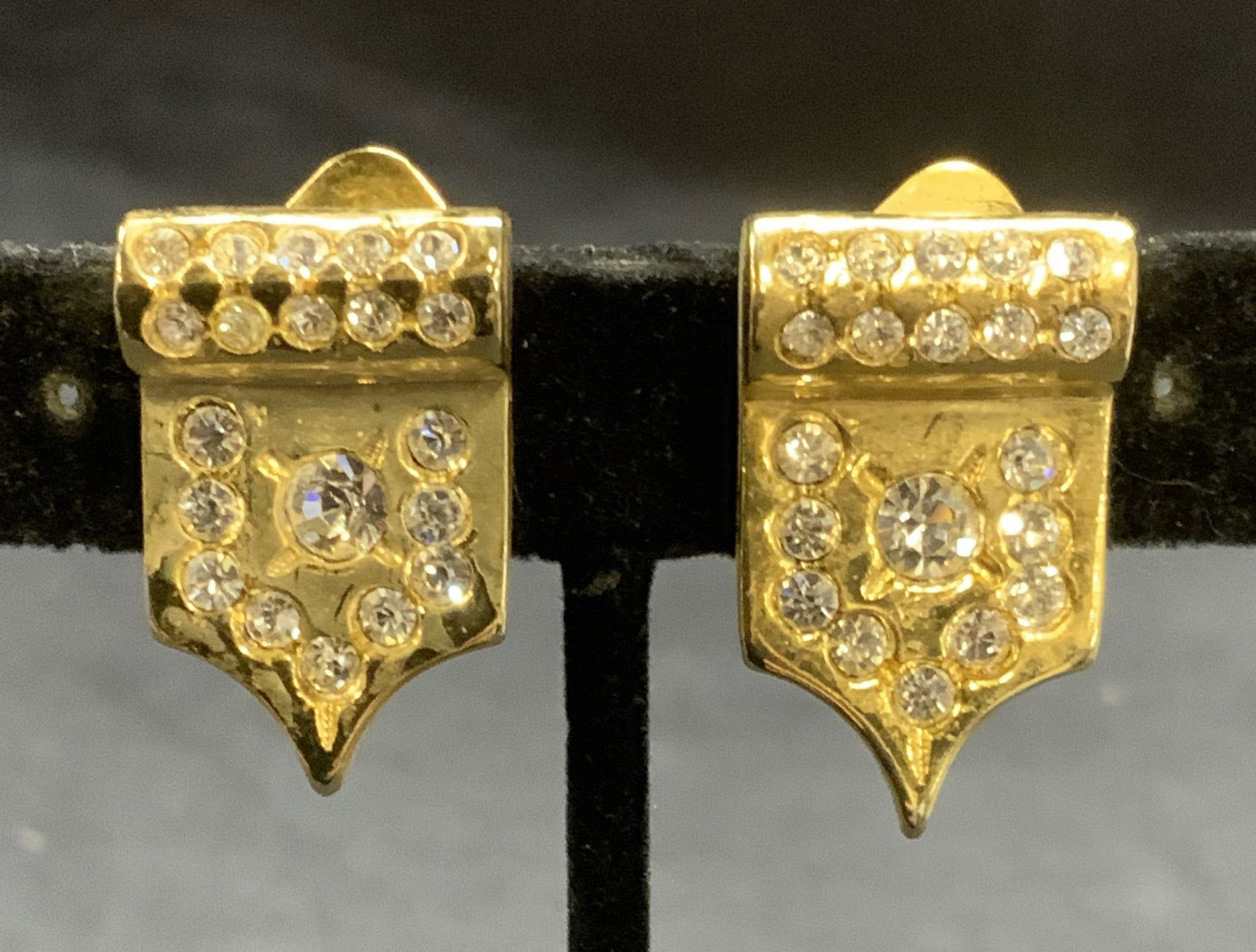 Vintage Gold Tone Crystal Earrings: Vintage gold tone and colorless crystal earrings. Clip on backing. Measures approx. 1 x .5 inches. Some scratching observed. Estate jewelry, costume jewelry, cocktail jewelry, fashion jewelry, accesso