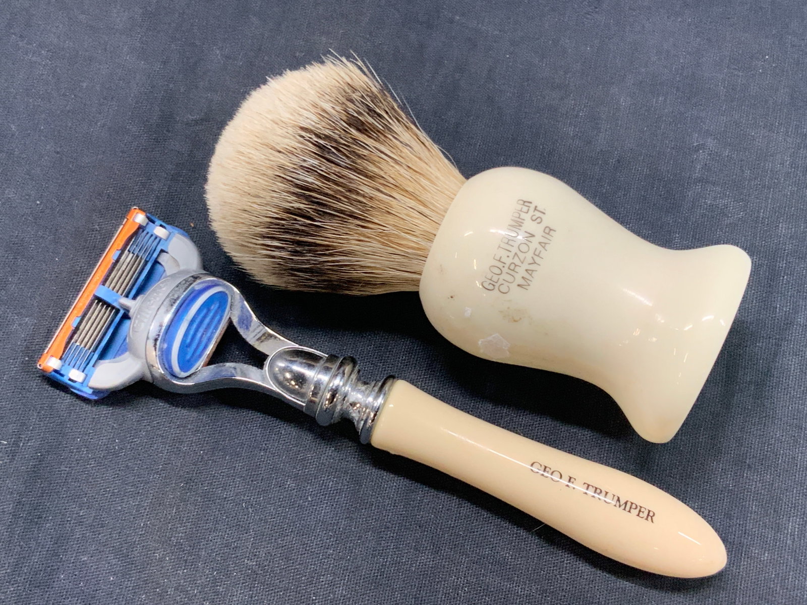 2 Vtg Trumper Mens Shaving Tools: Vintage set of shaving accessories, 1 shaving brush and 1 vintage Gillette razor, both with cream toned handles and marked Geo.F. Trumper. Approx 4 and 6 inches long Moderate wearing to shaving tools 