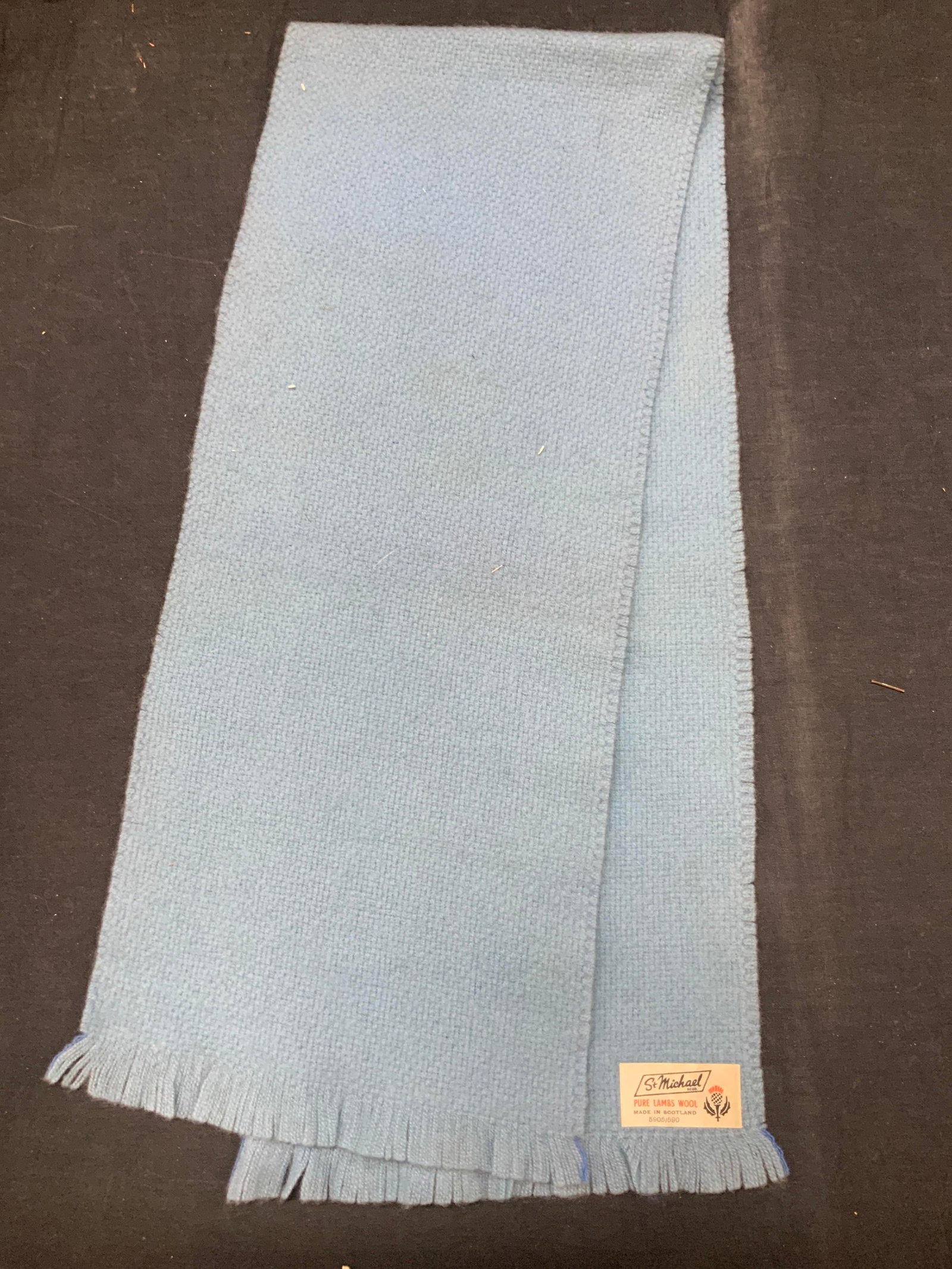 St Michael Lambs Wool Scarf, Scotland: Blue toned pure lambs wool scarf, made in Scotland, by St Michael. Approx 40 x 9 inches . Moderate blemishes to scarf due to age and use Wool scarf, lambs wool, scarf, winter scarf, ladies scarf, mens