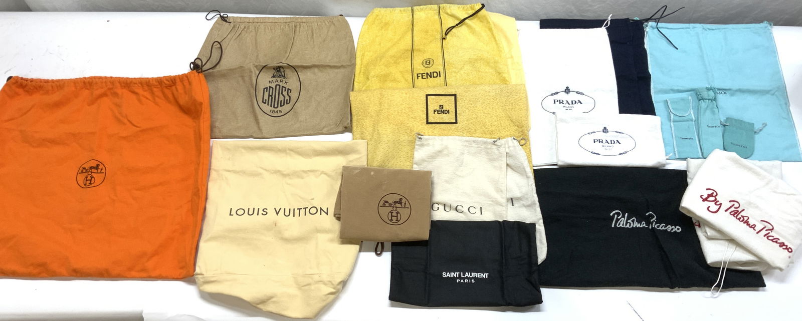 24 Luxury Brand Dust Bags, LV, Hermes, Tiffany +: Group of dust protection bags for pocketbooks, shoes, jewelry, more. Luxury designer brands included are Tiffany & Co , YVES Saint Laurent, Prada, Paloma Picasso, Louis Vuitton, Hermes, FENDI, Gucci,