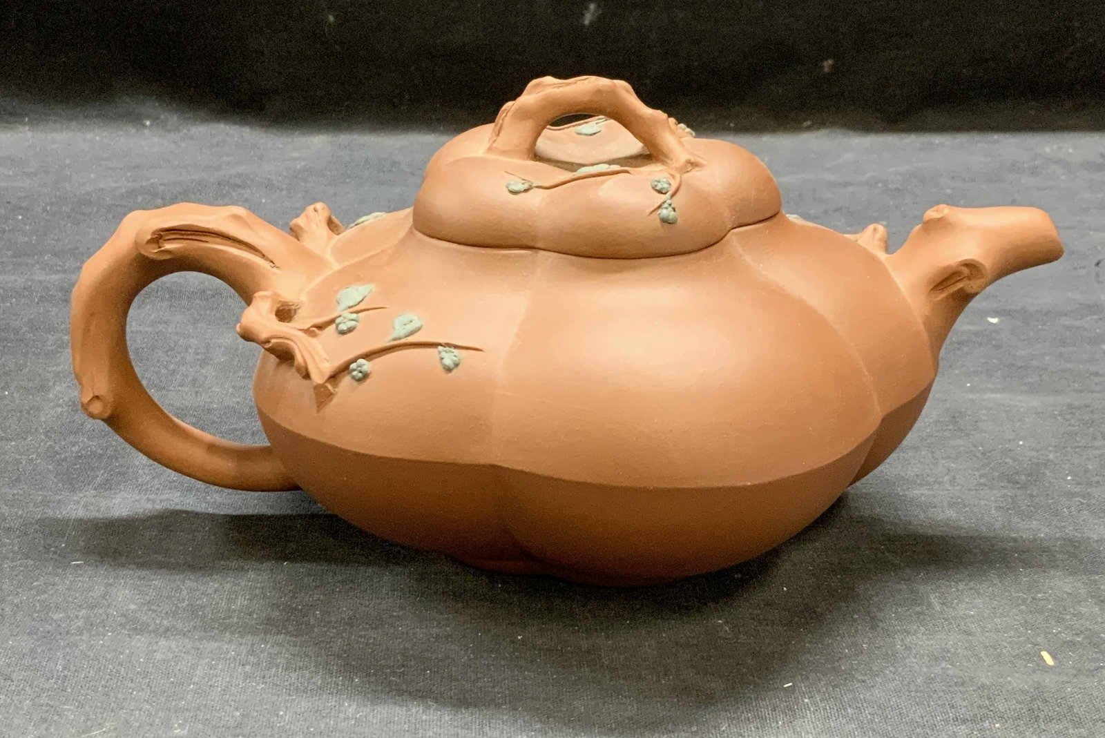 Chinese Yixing Pottery Zisha Teapot: Chinese Yixing pottery zisha teapot with raised branch motif. Measures approx. 8.5 inches wide and 4 inches tall including lid. Some surface wear consistent with exposure. Chinese teapot, zisha teapot