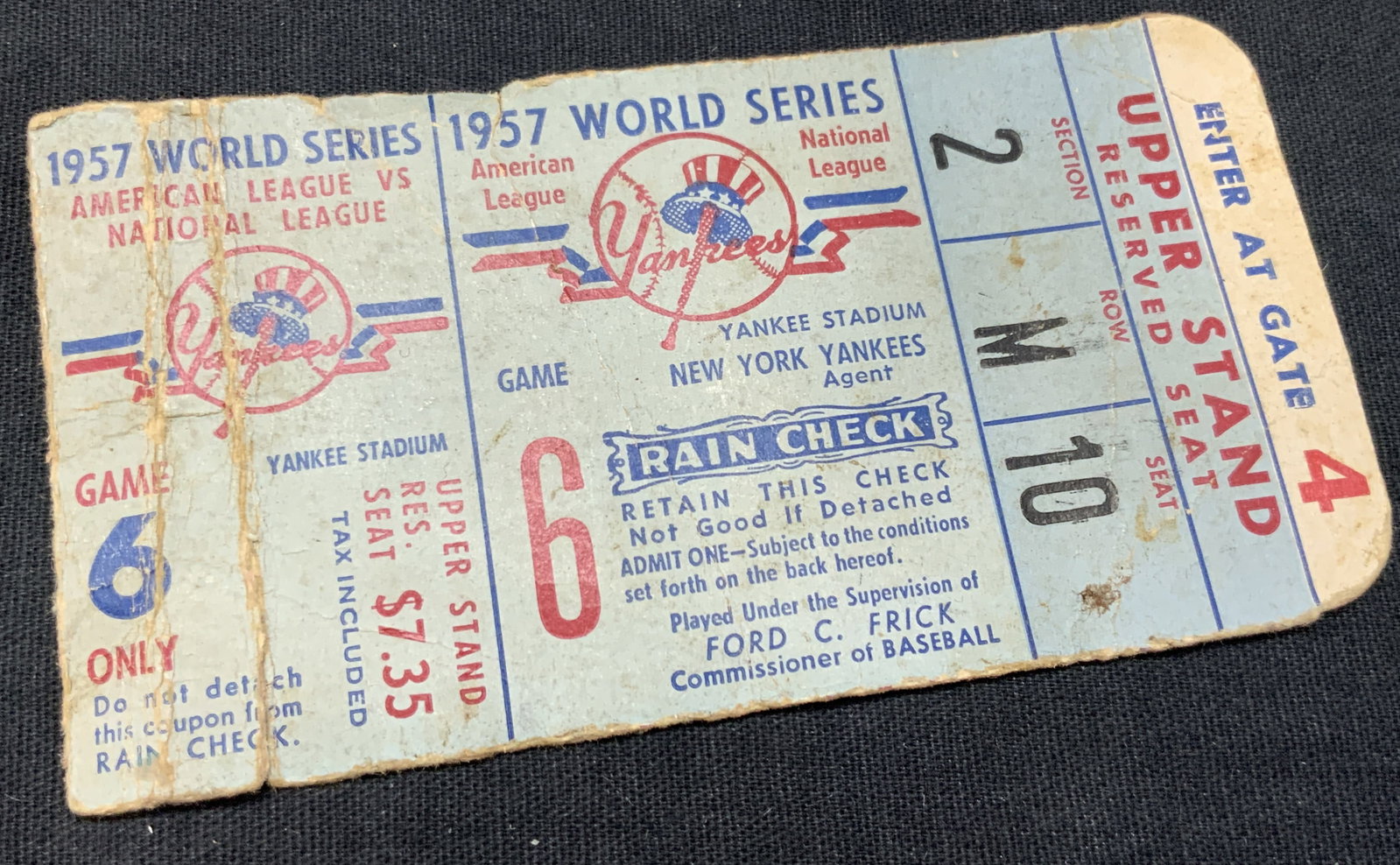 1957 World Series Yankee Stadium Ticket: 1957 Yankee stadium ticket for the World Series, American League vs National league. Ticket marked for the upper stand reserved seat. Approx 4 x 2 inches Evident creasing and tearing to ticket due to 