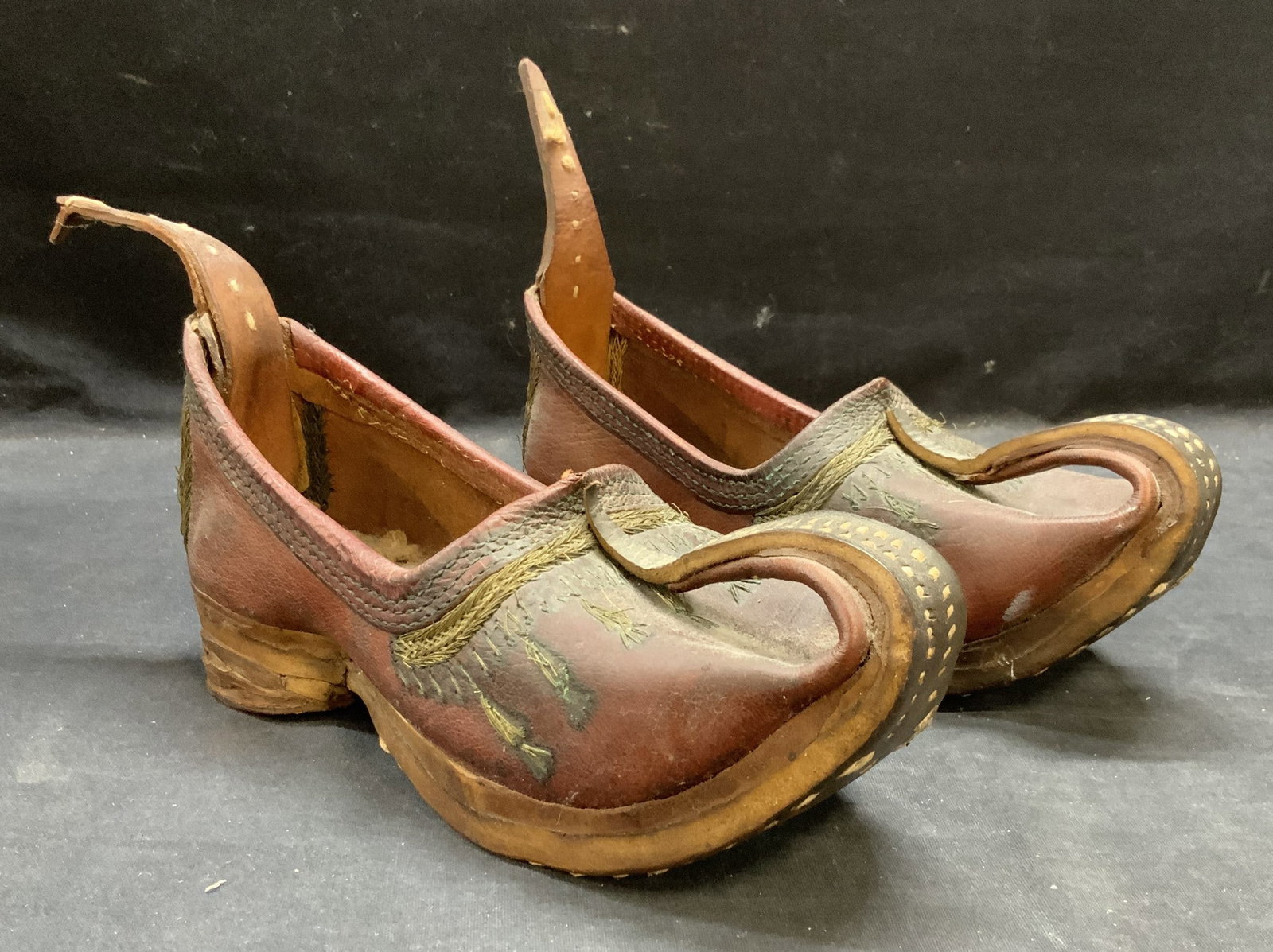 Pair Vintage Bhutanese Leather Shoes: Vintage Bhutanese leather shoes. Handmade with embroidered detail. Measure approx. 9.5 inches long from heel to toe. Wear to leather and material consistent with exposure. Bhutanese shoes, leather sho