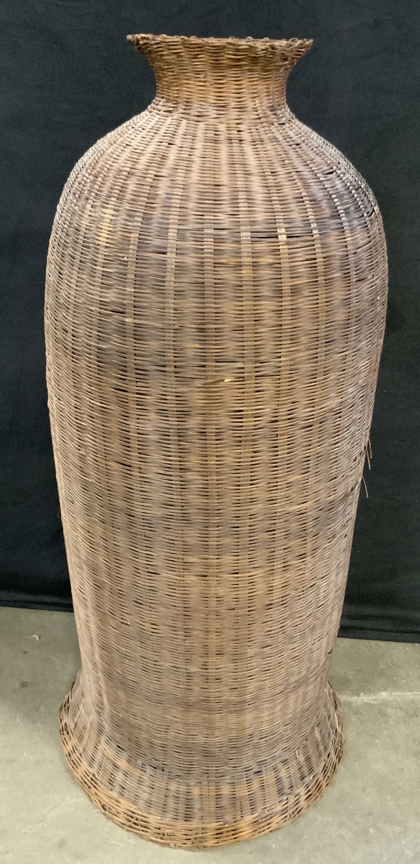 Woven Open Basket / Vase, 27.5 Inch Height: A open basket / vase woven from natural materials. Top and underside are open. Brown hues. Measures approx. 27.5H x 12W in. Some losses to material, separation, and indentation present. Collectibles, 