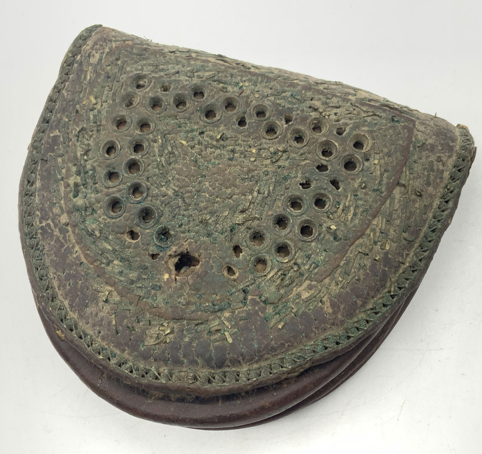 Antique Leather Crafted Afghan Coin Purse: Antique leather crafted coin purse, possibly from Afghanistan with intricate leather weaving on front with brown leather throughout and metal latch. Approx 4 x 4 x 1 inches Leather is stiff and has ev