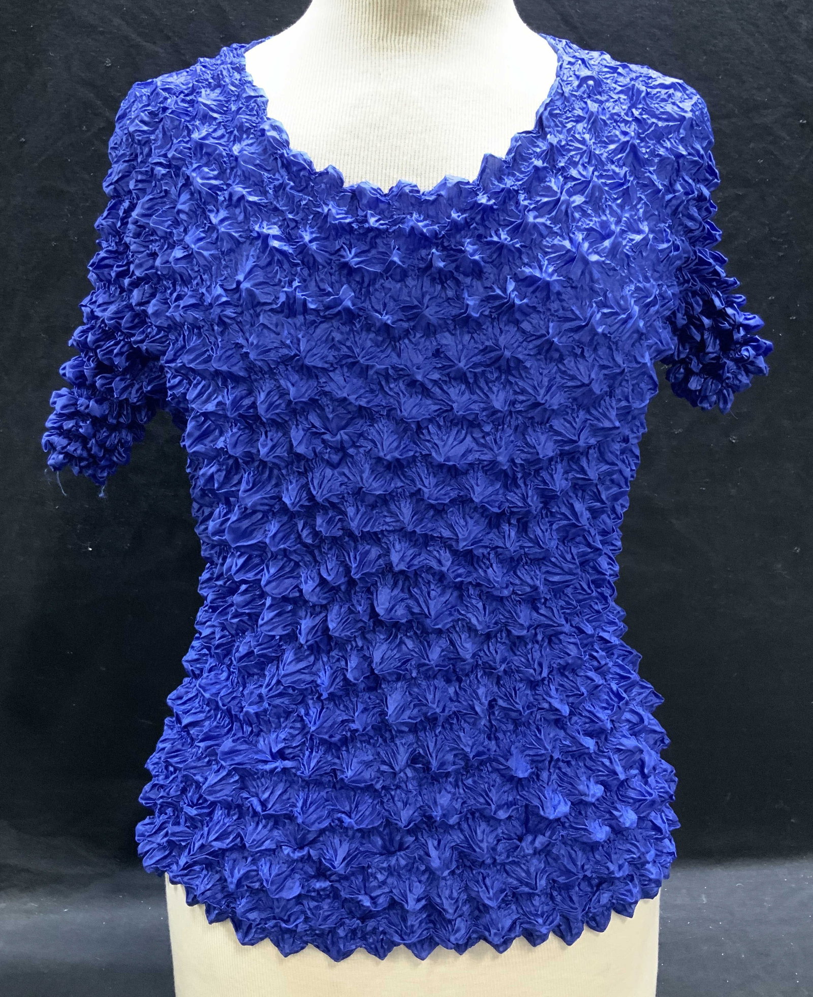 Vintage blue Ruched Short Sleeve Top: Vintage blue ruched short sleeve top. Synthetic material. Measures approx 22 inches across chest when stretched. Some wear to material consistent with exposure. Ladies top, ladies ruched top, ladies v