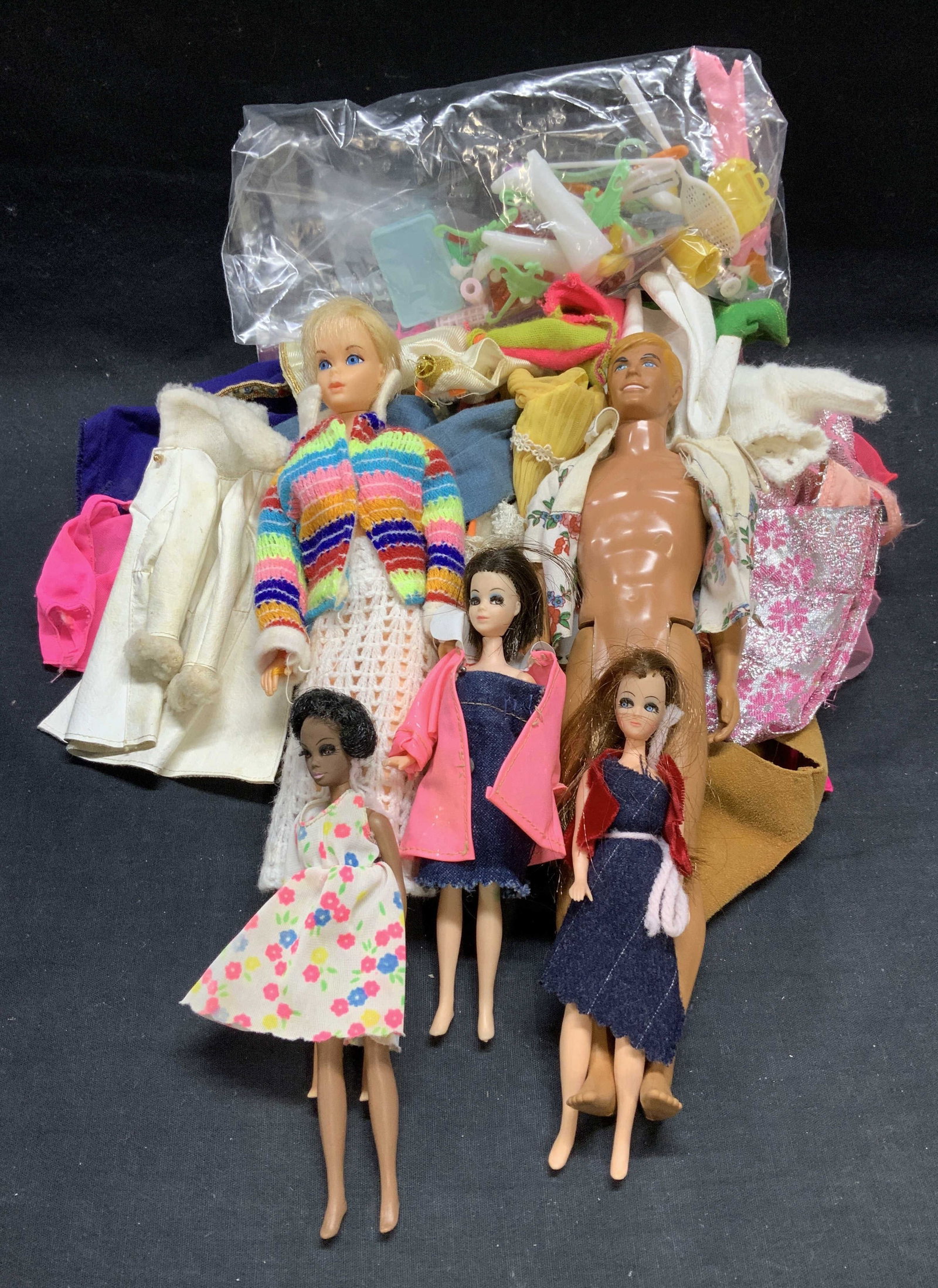Group Vintage Dolls, Doll Clothes & Accessories: Group lot of 25+ pieces of vintage dolls, doll clothing, and doll accessories. Ken doll marked Mattel 1968. Ken doll measures approx. 11.5 inches long. All pieces have surface wear including scratchin