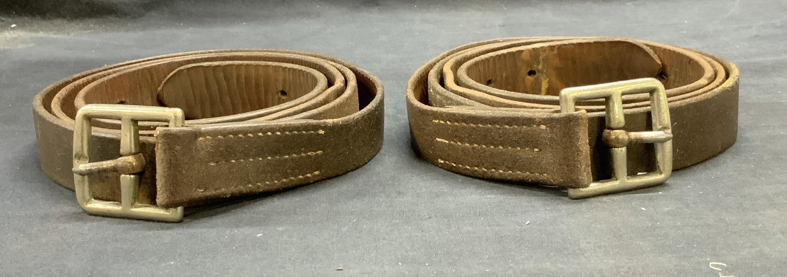 Lot 2 Vintage Brown Leather Belts: Lot of 2 vintage brown leather belts. Measure approx. 57 inches long each. Both belts have wear to leather including scratching and patina observed. Ladies belt, mens belt, ladies brown belt, mens bro