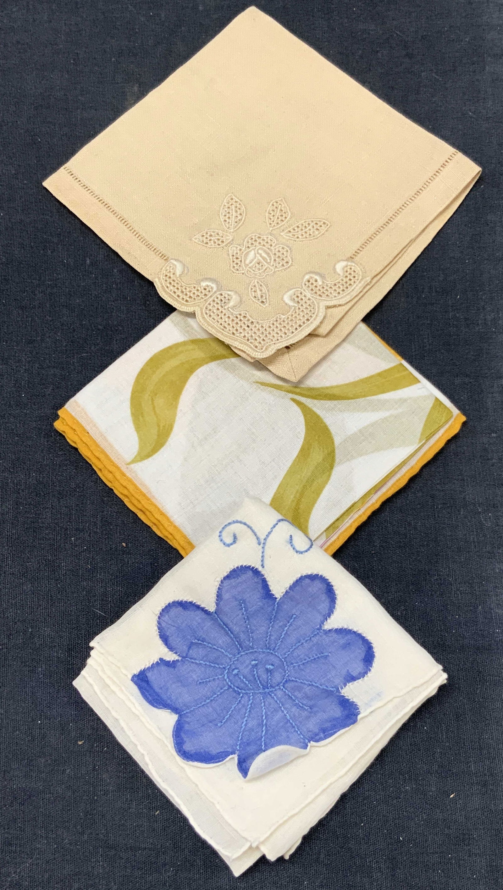 Lot 3 Vtg Handkerchief, Cotton & Linen: Lot of 3 vintage handkerchiefs. 1 linen with embroidered corner on white scroll designs. 1 printed with tulip and flowers with rolled edges and 1 off white linen handkerchief with blue applique and em