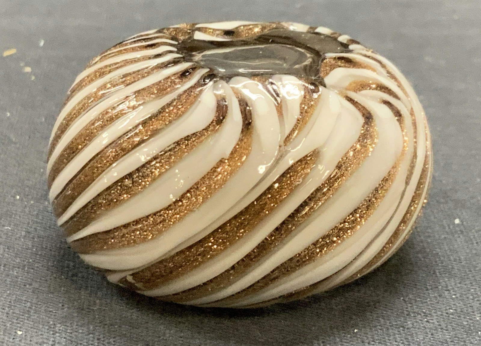 Gold & White Striped Art Glass Paperweight: Gold and white striped hand blown art glass paperweight. Measures approx. 2 inches wide. Some surface wear include in scratching observed. Art glass, art glass paperweight, striped paperweight, gold t