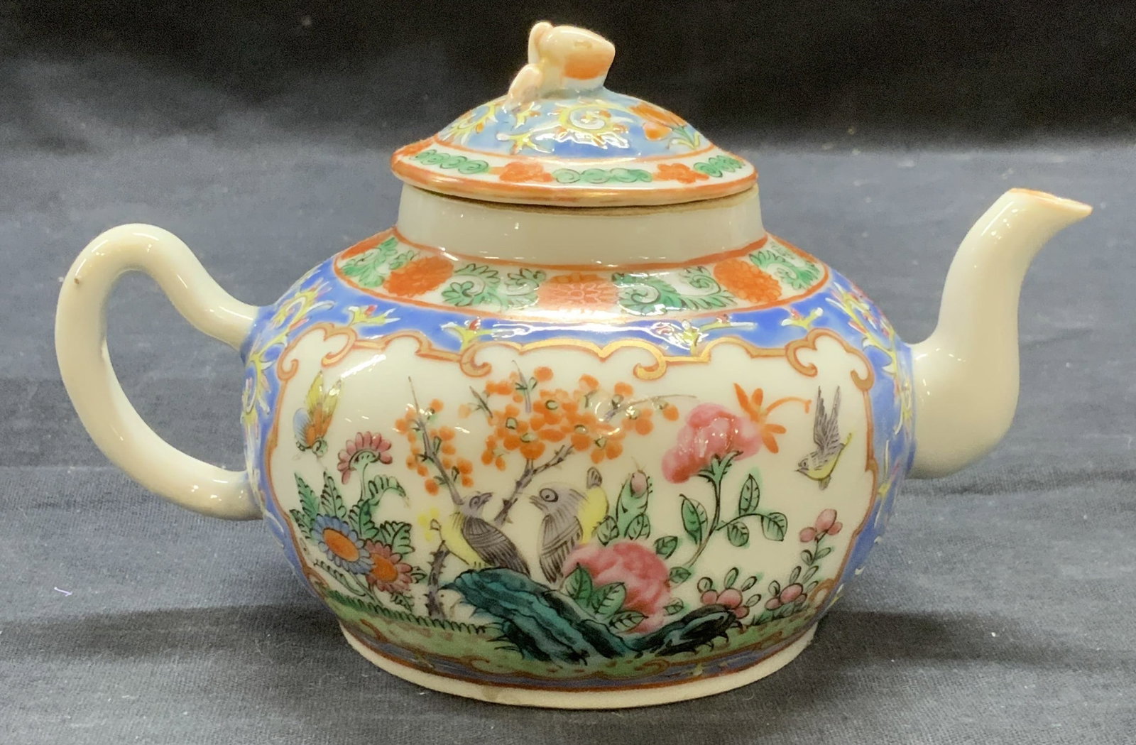 Antique Chinese Floral Porcelain Teapot: Antique Chinese porcelain teapot with hand painted floral motif. Hues of pastel blue, red, pink, and green. Measures approx. 6 x 3.75 x 3.5 inches. Some surface wear include in scratching observed. Te