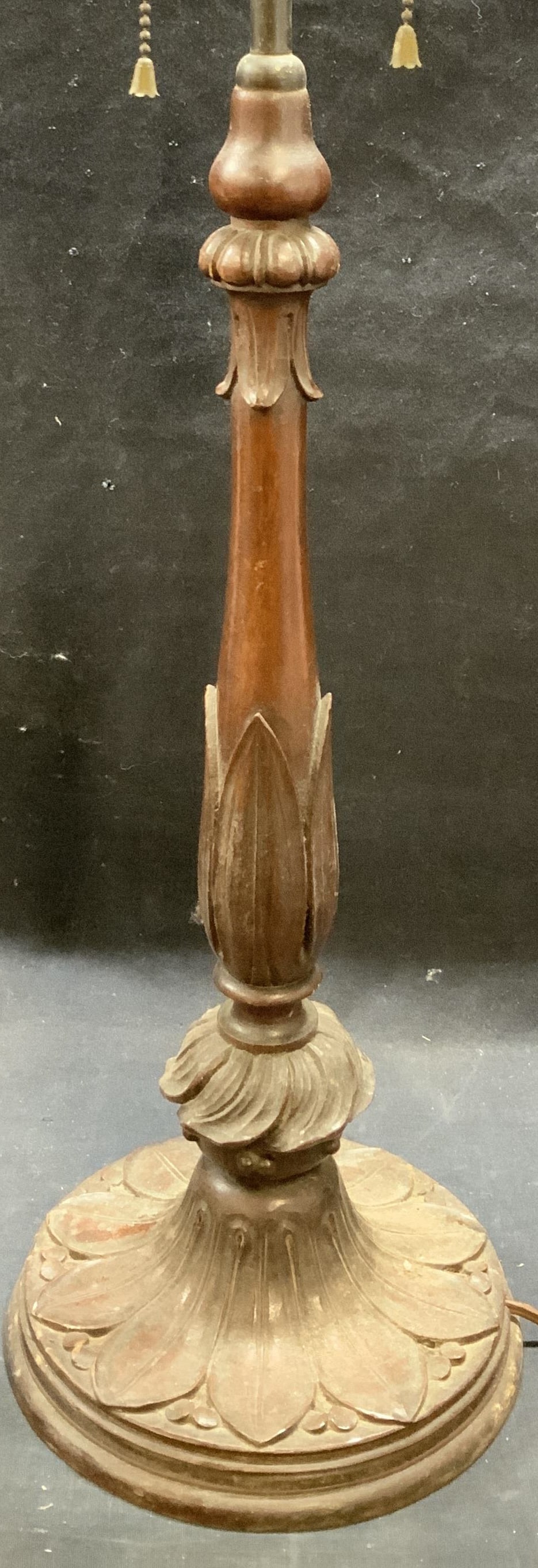Antique Carved Wood Table Lamp: Antique carved wood table lamp. Raised floral motif. Two sockets with pull cord. Measures approx. 7 x 26.5 inches including finial. Some surface wear including scratching observed. Not tested for func