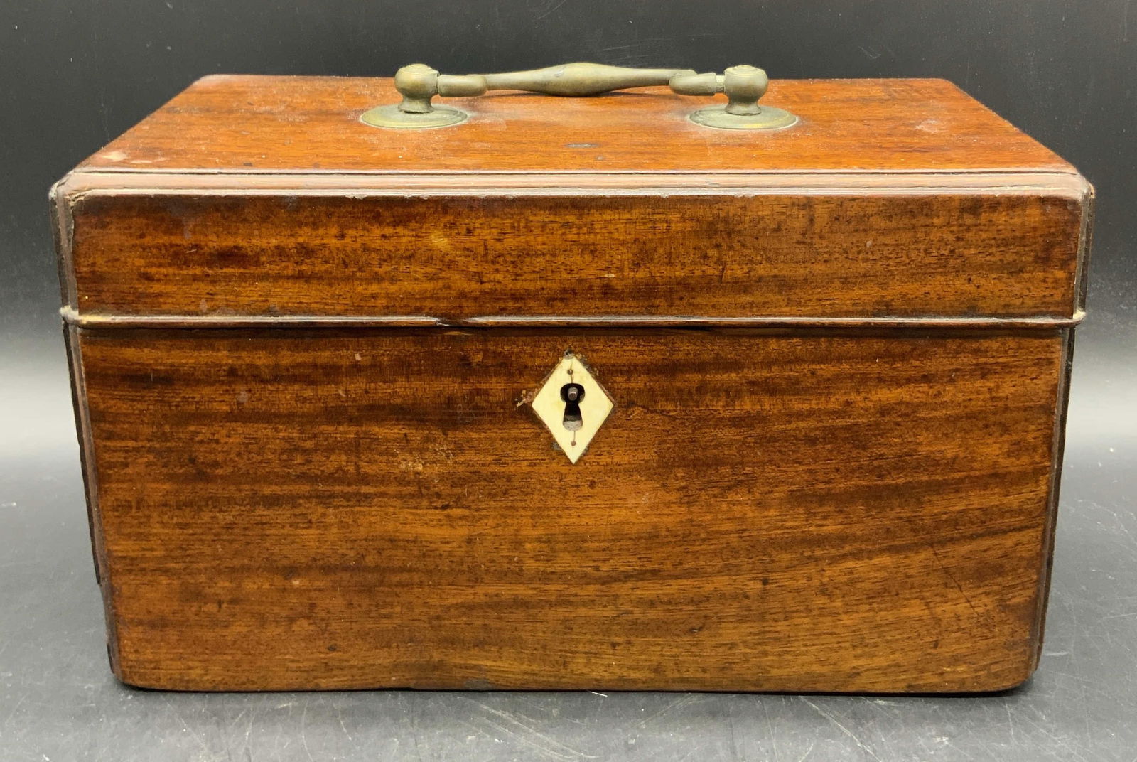 Antique Wooden Tea Caddy W/ Bone Inlay: Antique, possibly vintage, wooden tea caddy with a bone inlay to the obverse. Brass handle and hinge hardware. Compartments to interior for storage. Measures approx. 10.25W x 5.75H in. Losses, chippin