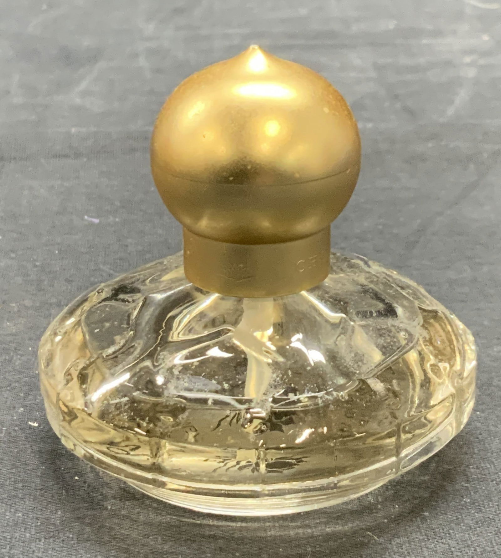 Chopard Eau de Toilette Perfume, France: Chopard Eau de toilette perfume in glass bottle. Made in France, 1.0 Fl. Oz size. Measures approx. 2.5 x 2.5 inches. Partially filled. Some wear to bottle consistent with exposure. Chopard, Chopard pe