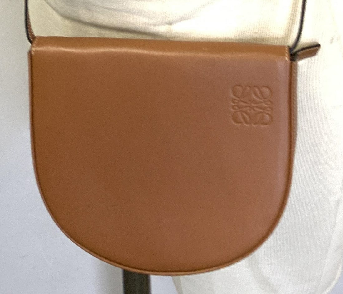 LOEWE Leather Crossbody/ Waist Bag, Spain: Light brown leather waist bag or crossbody/ shoulder bag. Signed Loewe and Made in Spain on interior. Fold over flap with magnetic closure. Strap has an adjustable buckle, drop is 23 in. ( can be 24 i
