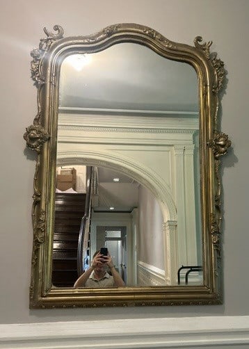 Antique Oversized Gold Leaf Wooden Mirror: Antique oversized gold leaf wooden mirror. Florals and scrollwork throughout. Measures approx. 42.5W x 62H in. Original to the house belonging to famous sculptor artist Elie Nadelman, early 1900s. Whi
