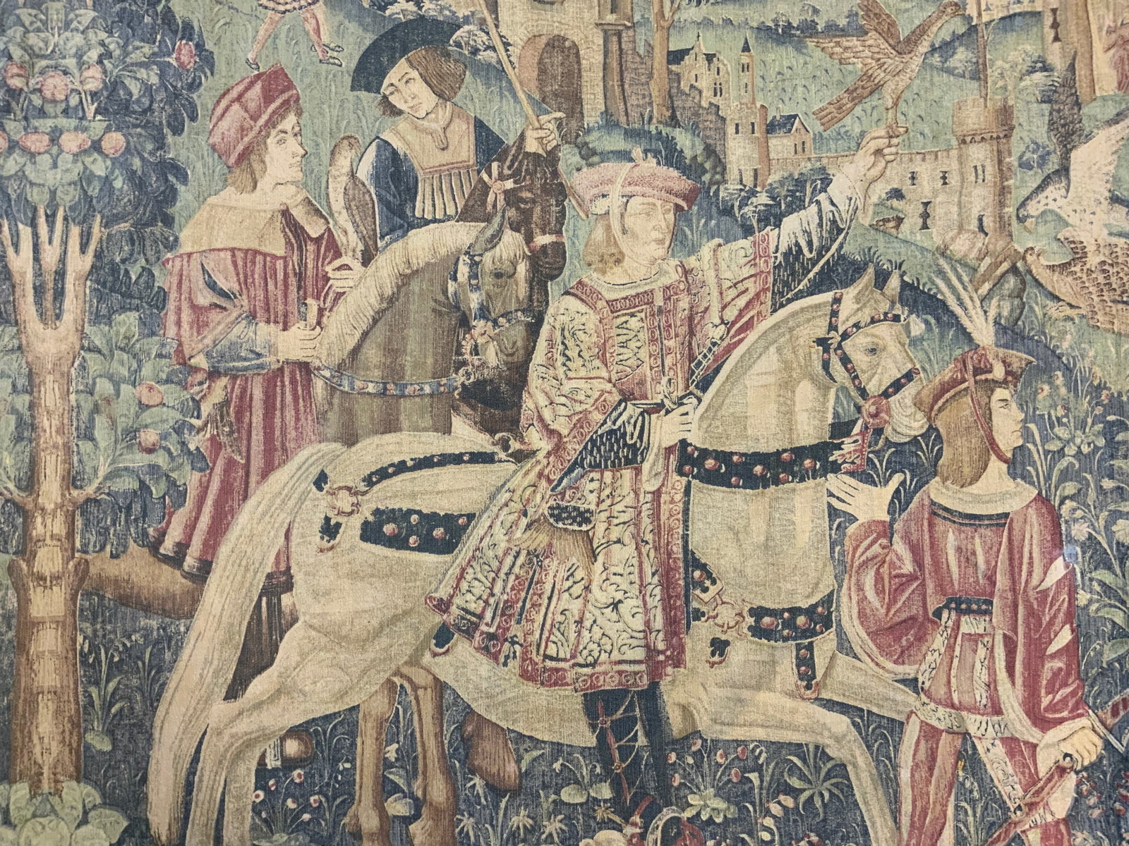 Vintage Printed Canvas Tapestry: Tapestry is vintage. Piece appears to be canvas. Tapestry has canvas. Piece has landscape image with figures on horseback, castle in the background. Measures approximately 61 inches long 55 inches tal