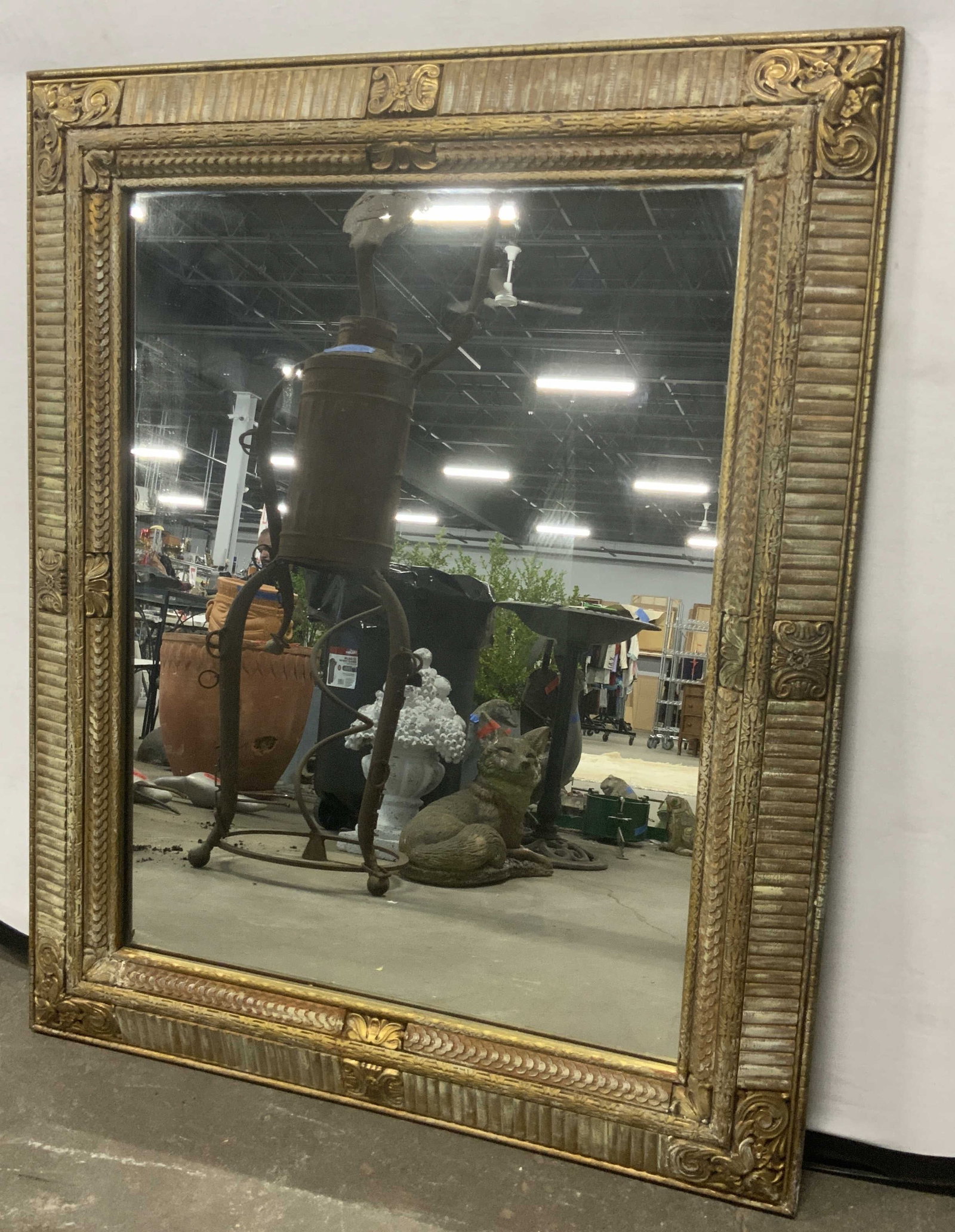 LOESERS Vintage Carved Gilt Wood Wall Mirror: A vintage carved gilt wood wall mirror. Measures approx. 43.5L x 35.25W in. Sticker to reverse is dated 3/7/50. Sticker reads LOESERS ART GALLERIES. Some surface wear and chipping present. Paper to re