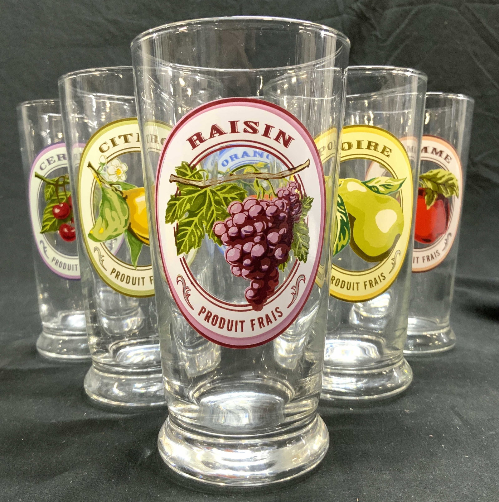 PRODUIT FRAIS Lot 6 Drinking Glasses Vessels: Each cup trademarked PRODUIT FRAIS. Each glass has different fruit Lot includes RAISIN, CITRON, POIRE, ORANGE, POMME, & CERISES. Each cup is glass, each measures approximately 6 inches tall 3 inches w