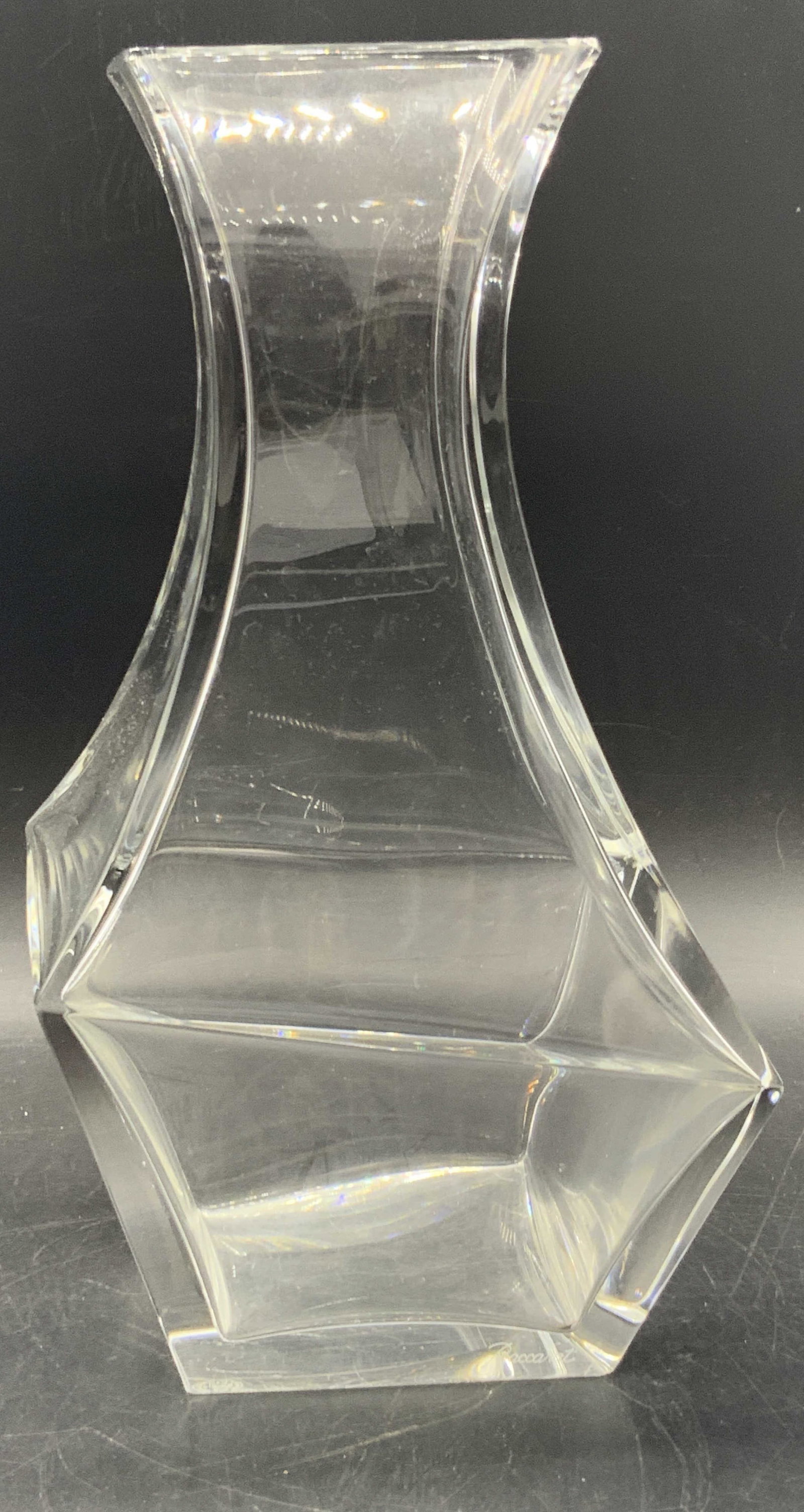 BACCARAT FRANCE Asymmetrical Crystal Vase: A asymmetrical crystal vase by Baccarat. Trademark to underside reads BACCARAT FRANCE. One side towards base also signed BACCARAT. Measures approx. 10.5H x 5.75W in. Measured at widest point. Some sur