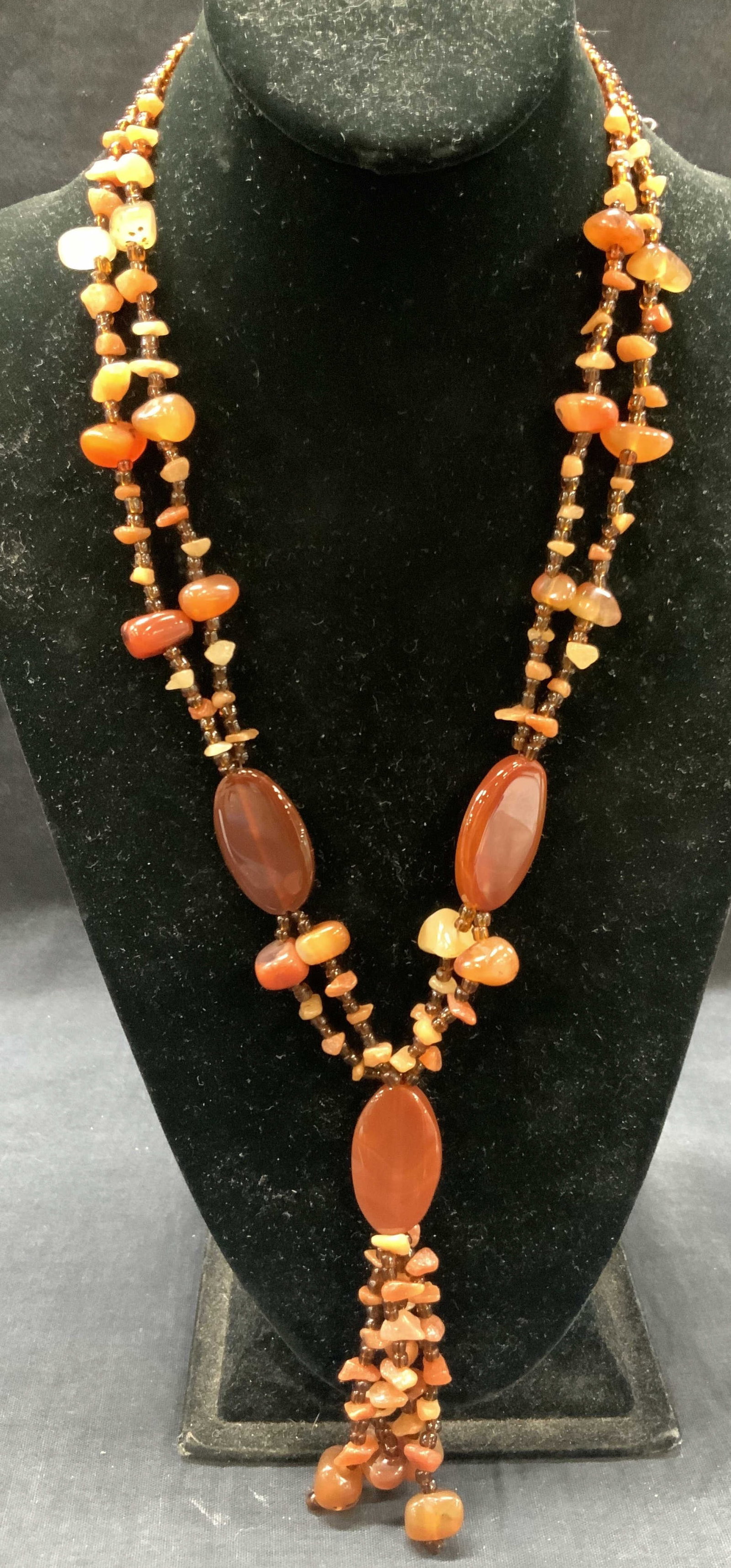 Carnelian Quartz Beaded Necklace: Necklace with amber toned glass beads and raw carnelian Quartz stones and polished carnelian larger beads. Approx 11.5 inches long Largest stone beads being 1.25 inches long. Total weight 102.1 grams 