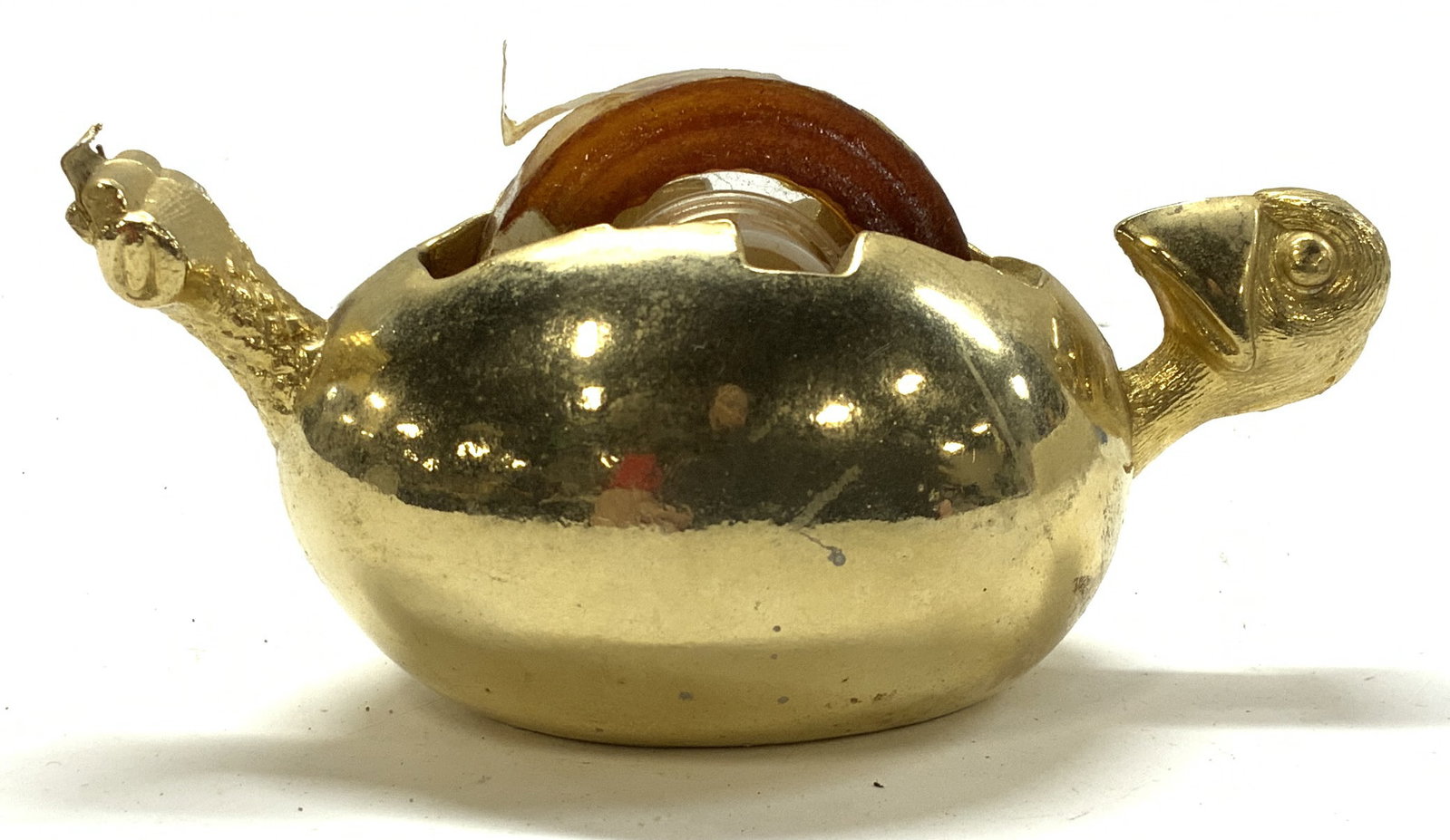 Brass Tape Dispenser, Bird Hatching From Egg: Vintage tape dispenser in gilt brass of a bird hatching out of an egg. Measures 5.5 in, long x 2.75 in. Wide x 2.5 in. Tall. Insert for the tape dispenser core present. Hallmarked on interior, illegib