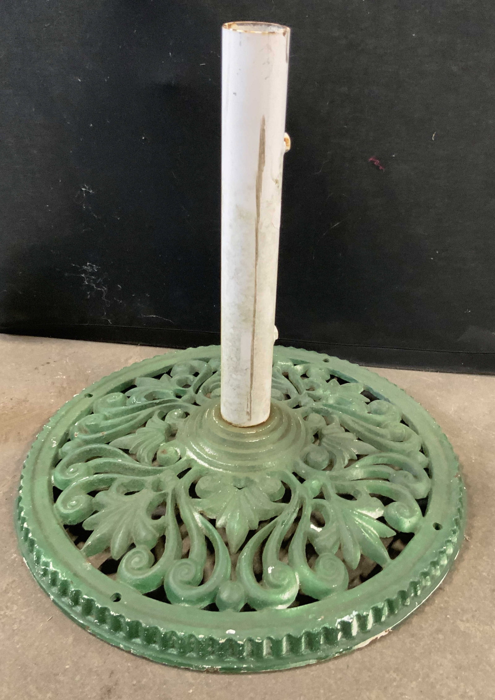 Vintage Green Iron Umbrella Stand: A vintage painted green iron umbrella stand. Open metalwork design. Measures approx. 16H x 17W in. Weighty. Wear consistent with age, use, and exposure. Some discoloration present. Some loose pieces. 