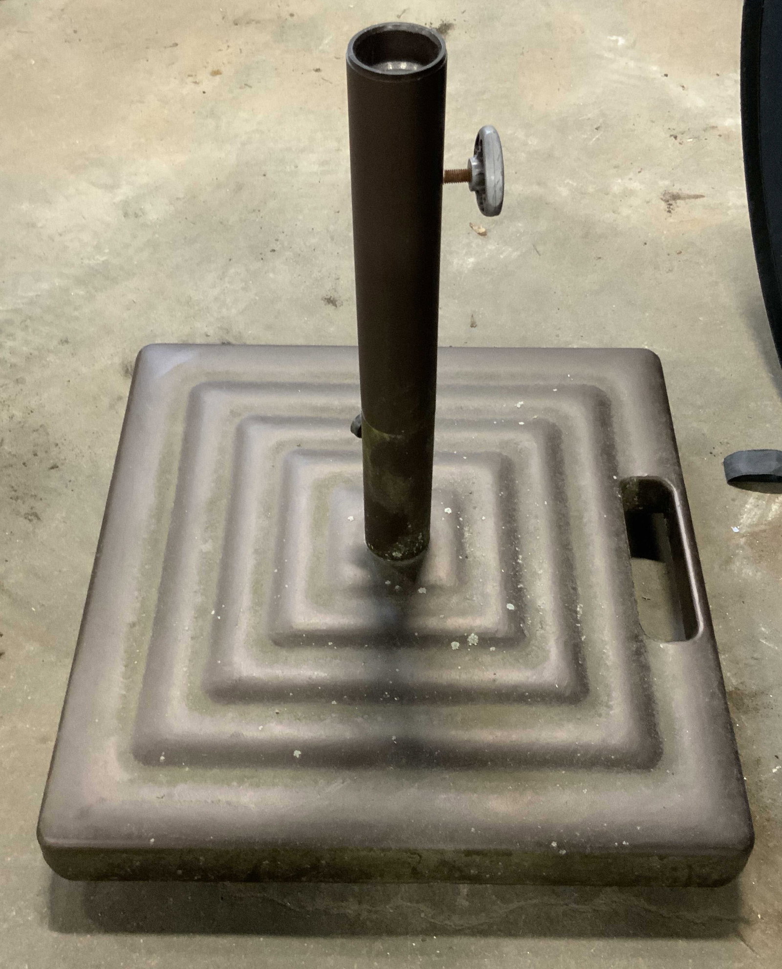 Square Form Metal Umbrella Stand: Very weighty metal umbrella stand. Square form. Handle to one side. Wheels to underside. Measures approx. 19H x 19W in. Wear consistent with age, use, and exposure. Metalware, metalwork, decorative ar