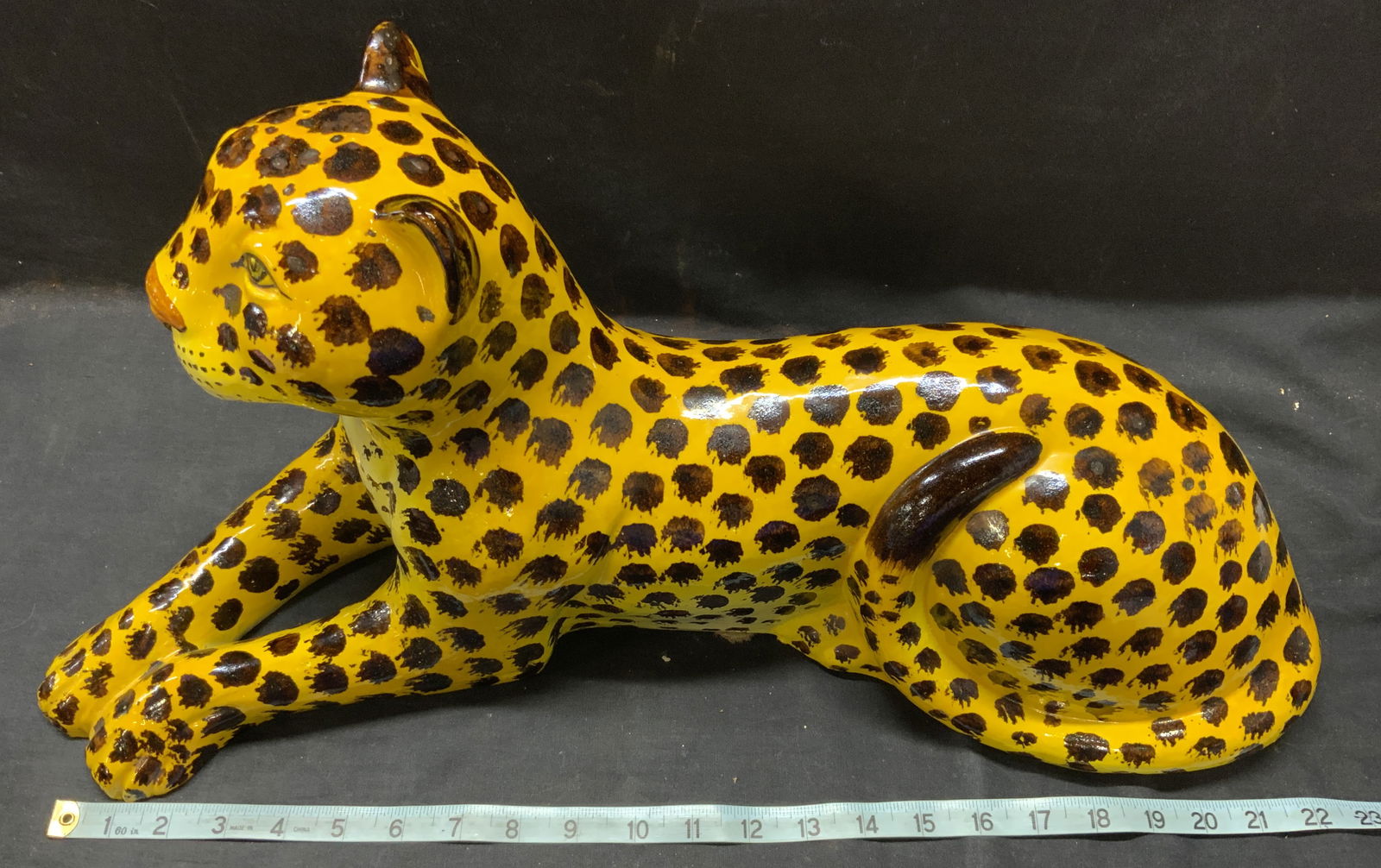 Hand Painted Terracotta Cheetah Figural, Italy: Hand painted terracotta cheetah, bright yellow with brown spots. Hollow figural. 23 in. Long, 10.5 in tall x 6.5 in. Wide. Handmade in Italy. Label on interior. Cheetah sculpture, luxury African anima