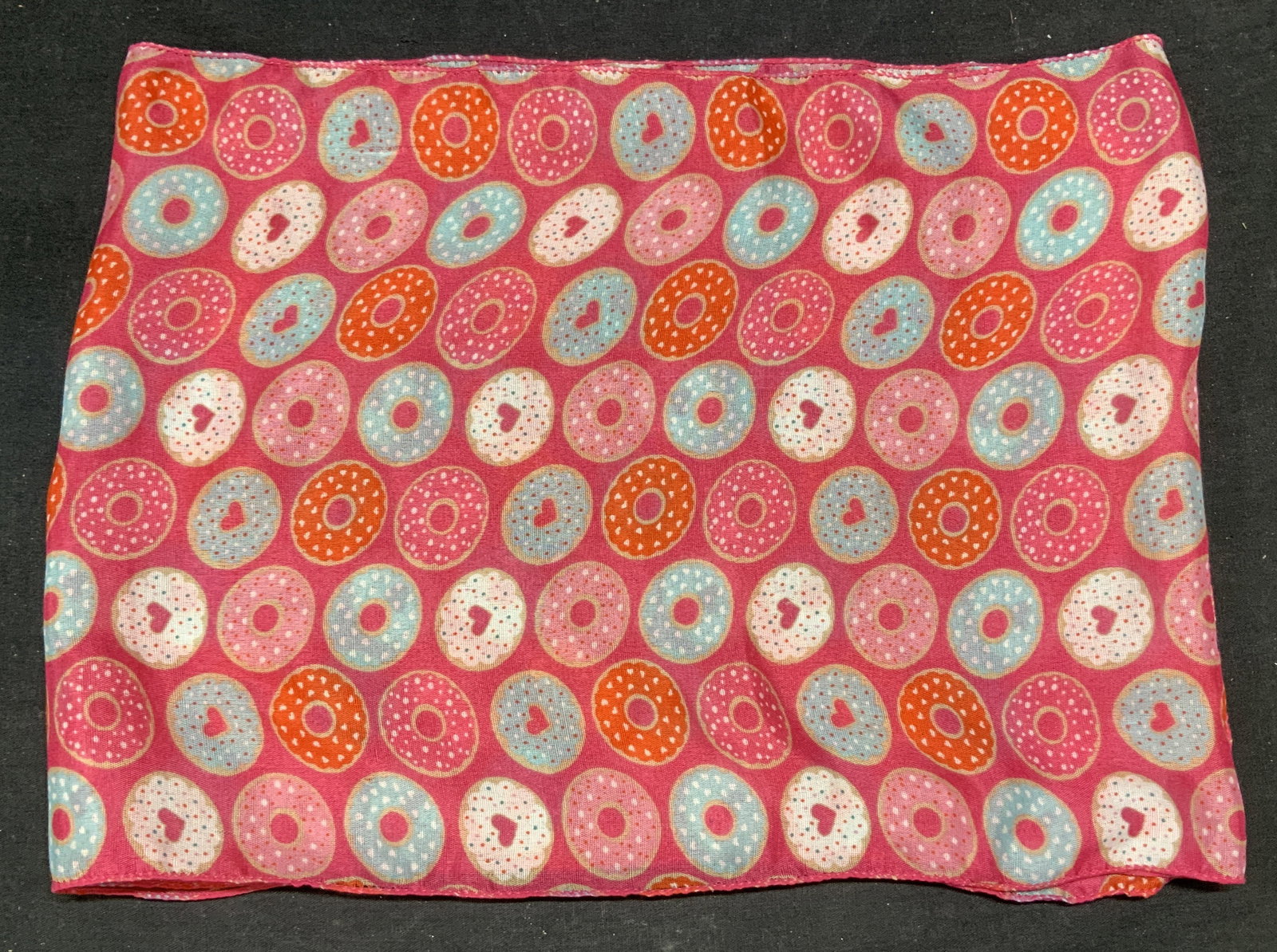 Pink Donut Print Scarf: Pink donut print scarf. 100% polyester. Measure approx. 58 inches long. Some wear to material consistent with exposure. Ladies scarf, ladies donut scarf, ladies pink scarf, ladies printed scarf, ladie