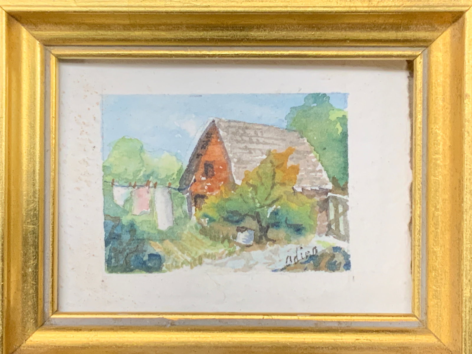 Sgd 1993 Watercolor Cottage Miniature Painting: Signed on back behind the castle, original by Helen Adina Smith, 1993 Watercolor painting of a red house with laundry on the line. Framed in a gold leafed wooden frame approx 3 x 3.5 inches window mea