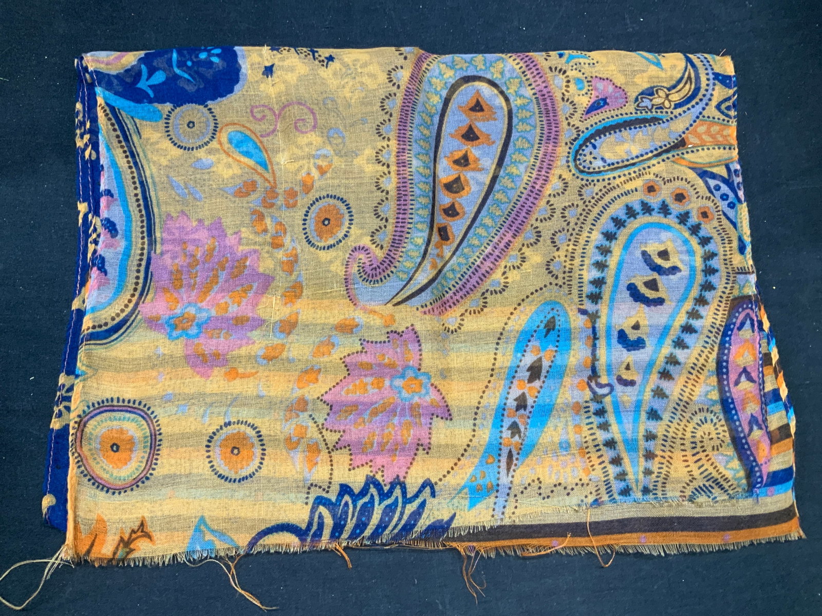 Blue & Orange Paisley Print Scarf: Blue and orange toned paisley print scarf. Soft hand material, feels like cotton. Measures approx. 50 inches long. Some wear to material including pulling observed. Ladies scarf, ladies orange scarf, 